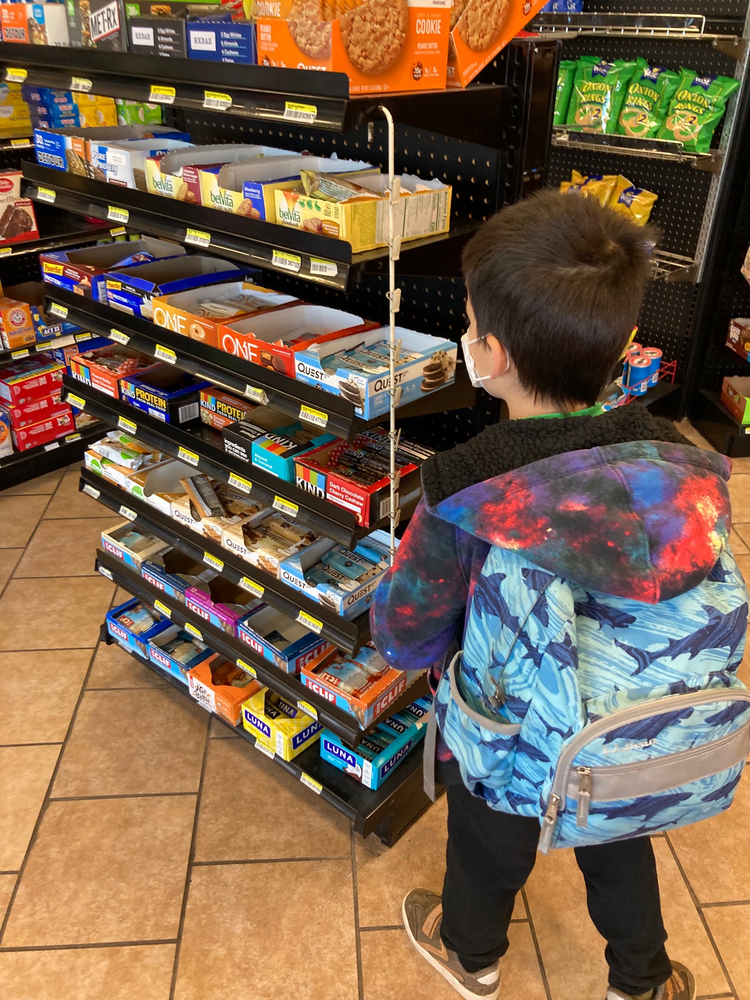 The guy is fascinated by this combination Dunkin’ Donuts and convenience store. Being a kid is somet