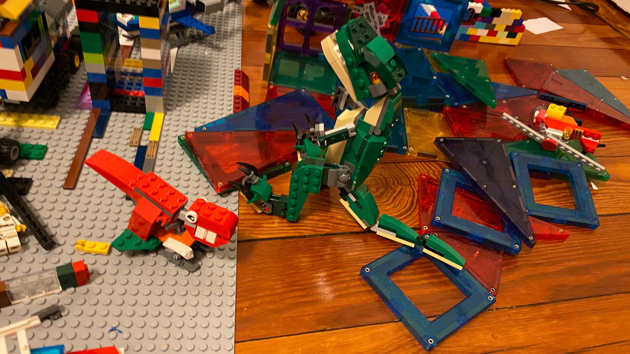 Small red dinosaur with one giant foot on snowmobile is my favorite Lego guy.