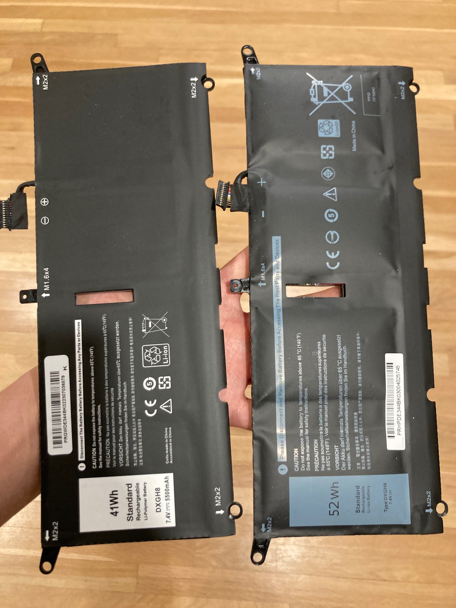 Two laptop batteries, one swollen