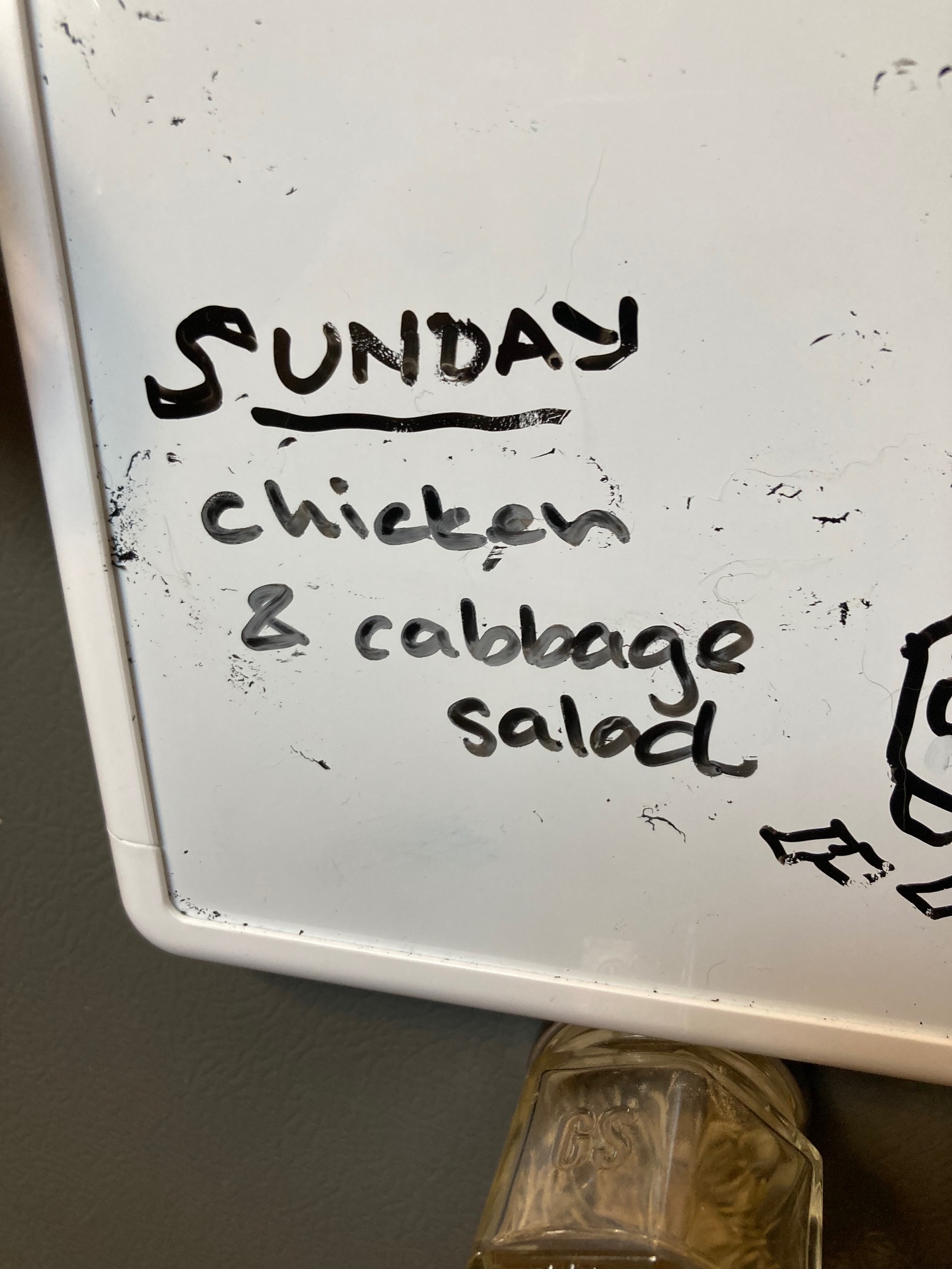 White board with “chicken and cabbage salad” written on it