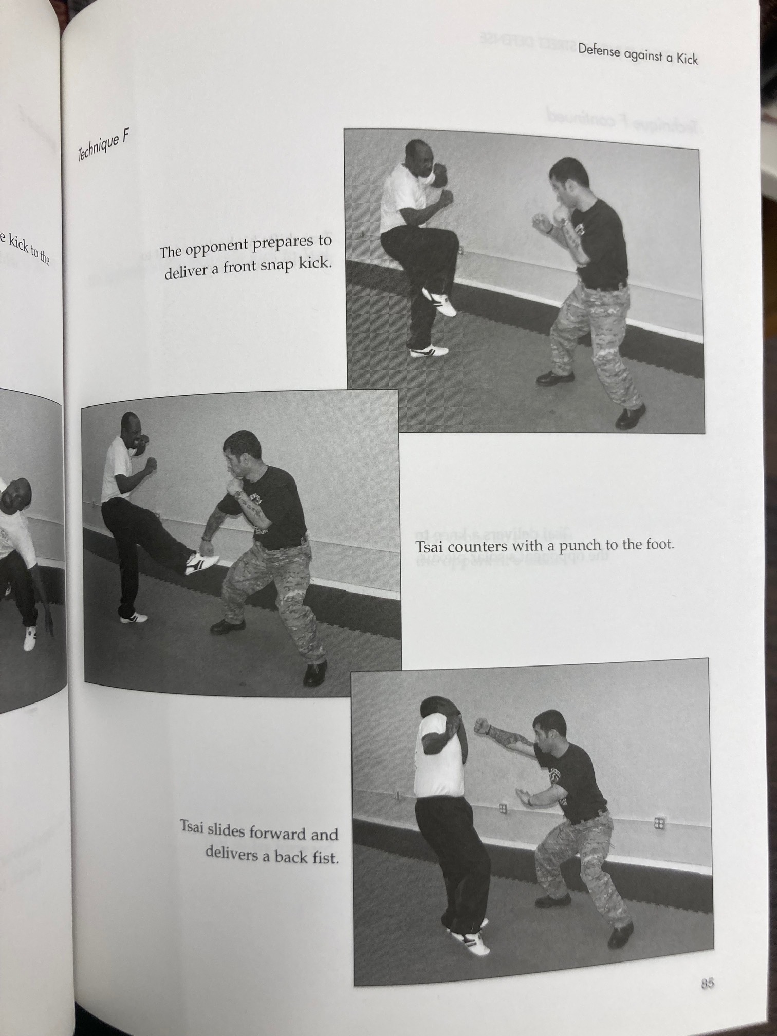 Book page showing a man punching a foot as he is being kicked
