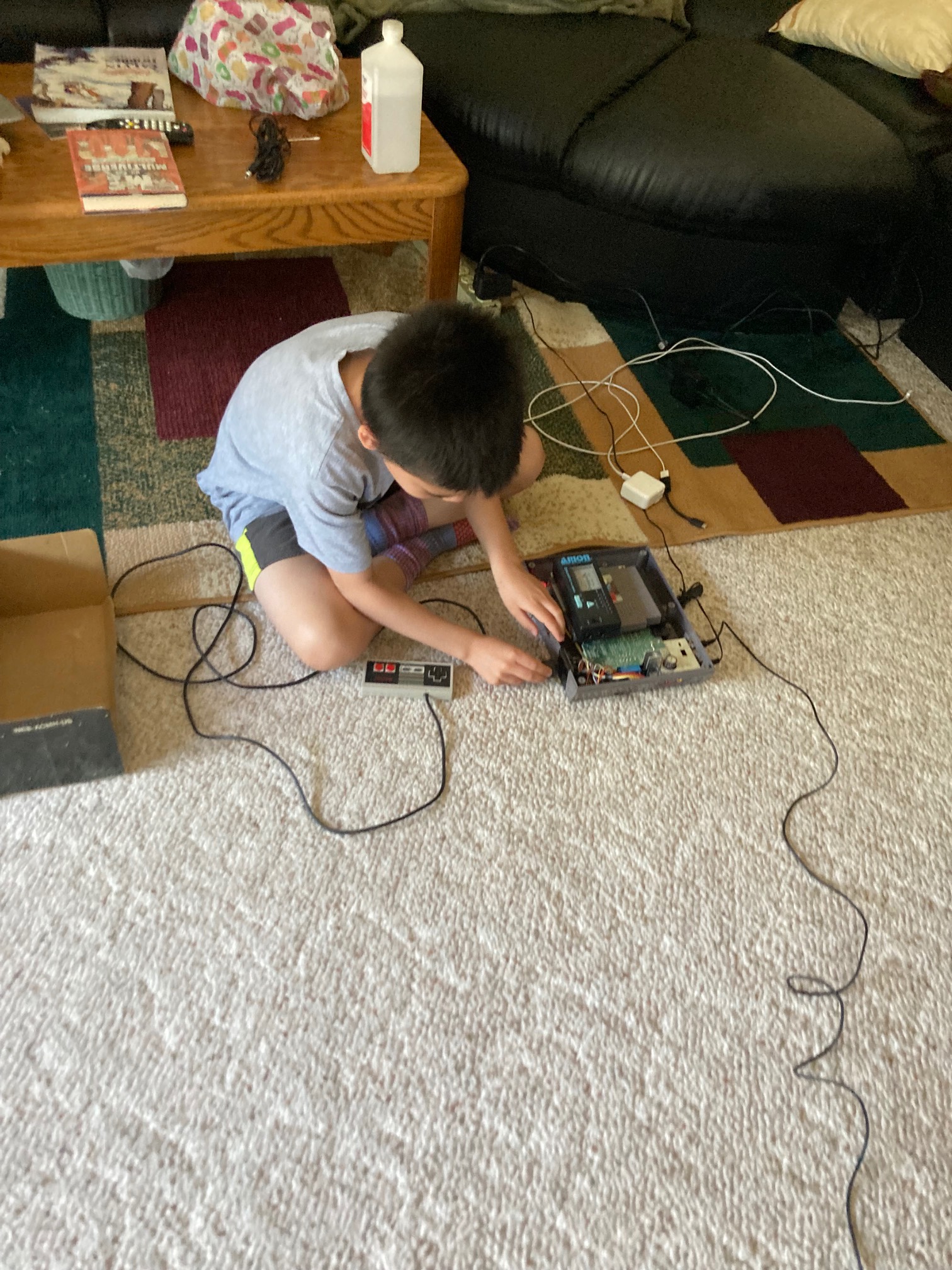 Kid plugging controller into NES