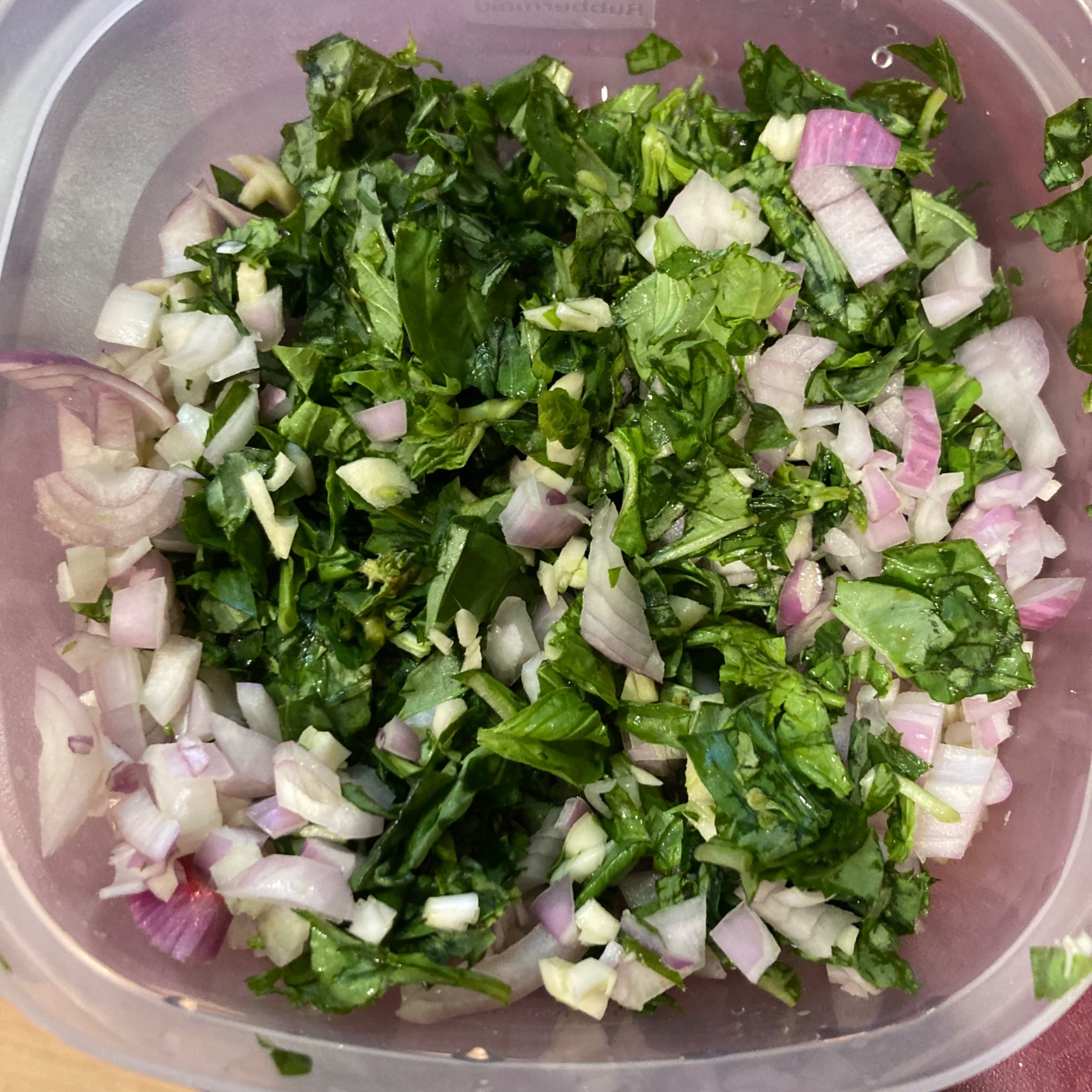 Chopped basil with shallots in a container