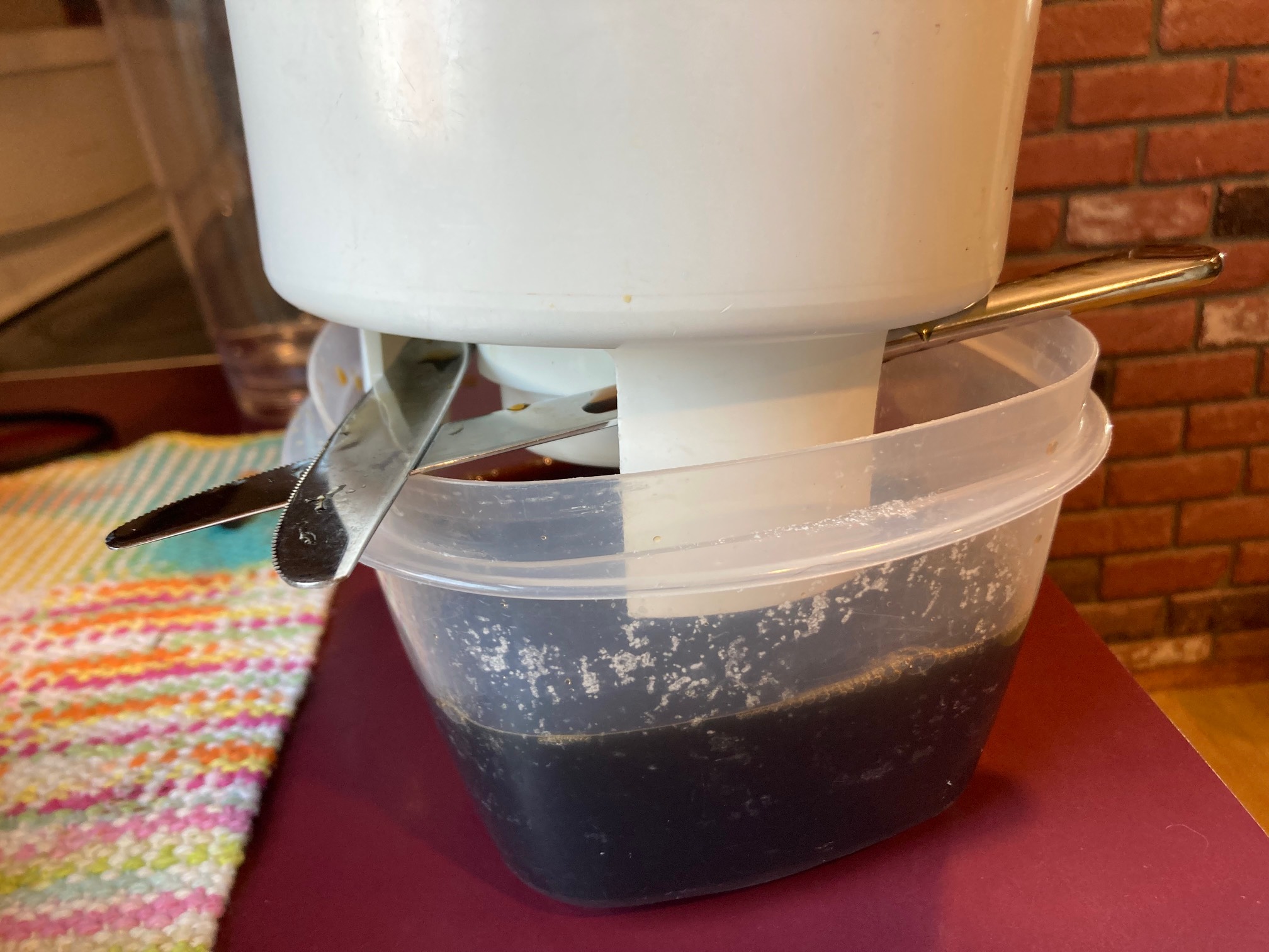 Iced coffee toddy over a container of iced coffee
