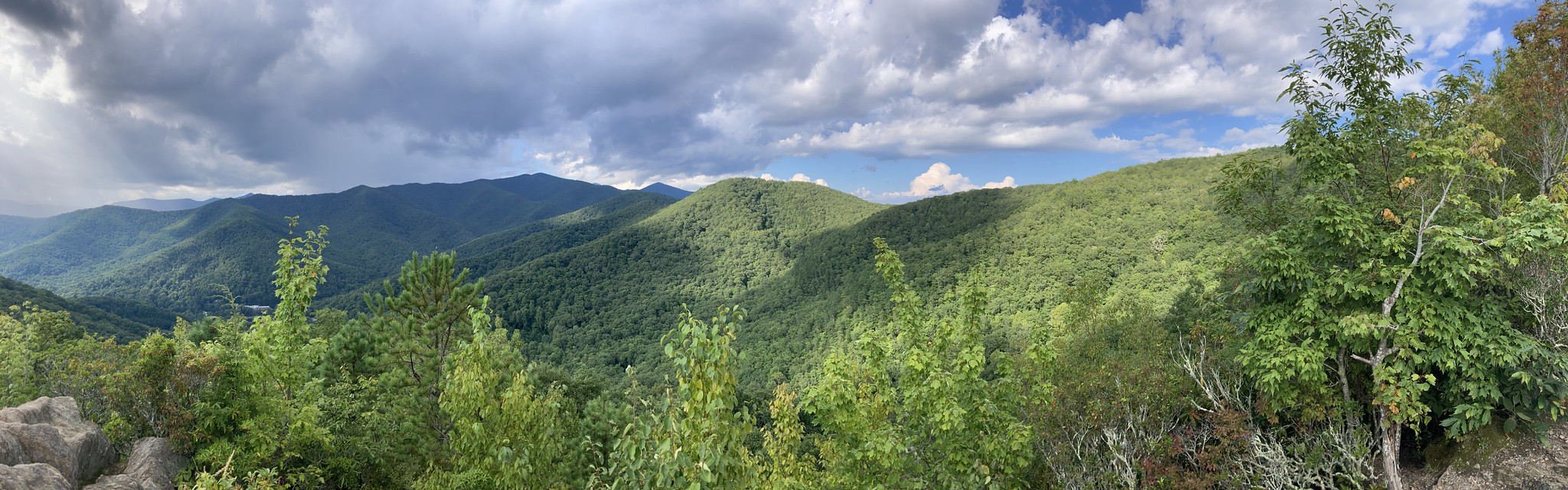 Forested mountains with clouds overhead