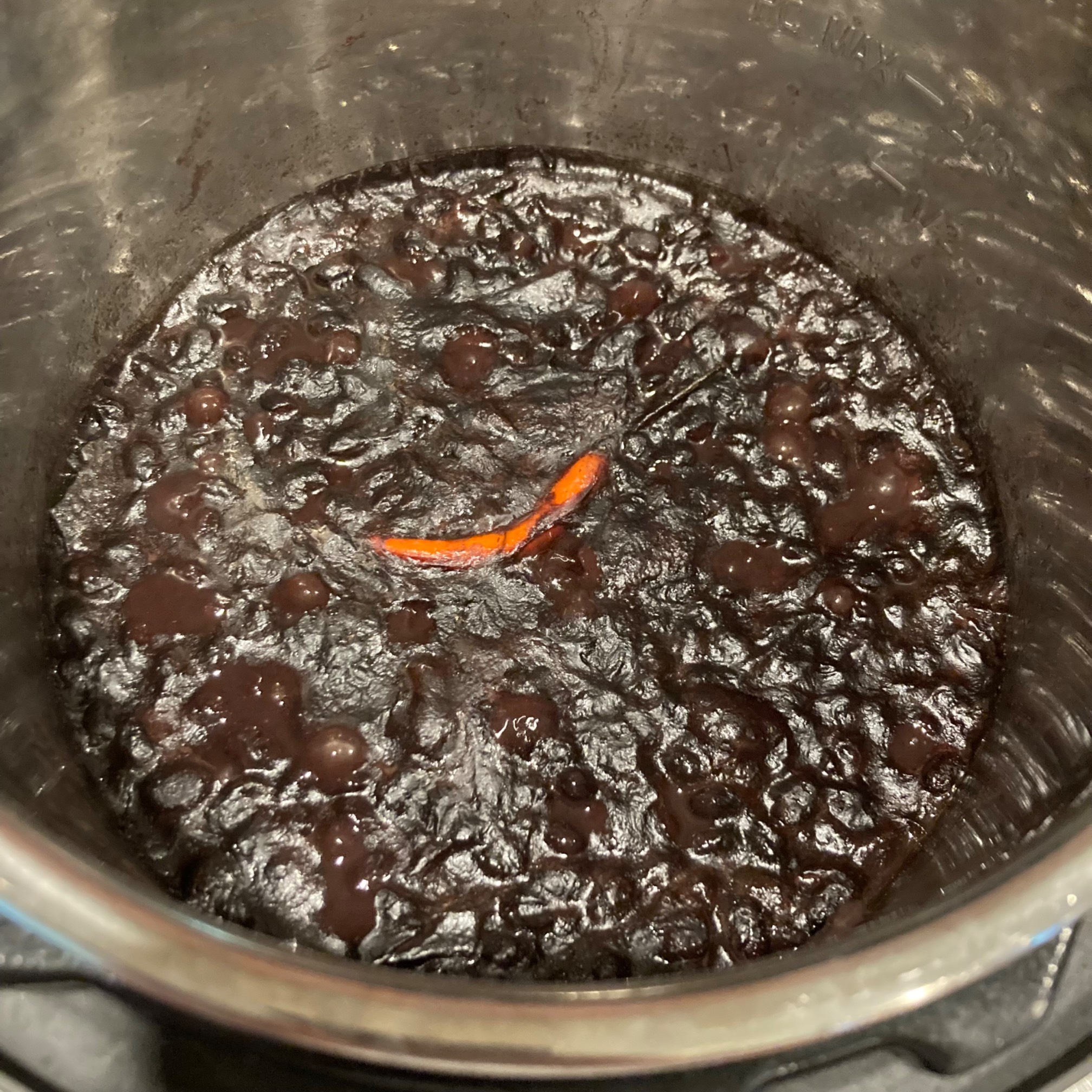 Pot of beans with a Thai pepper