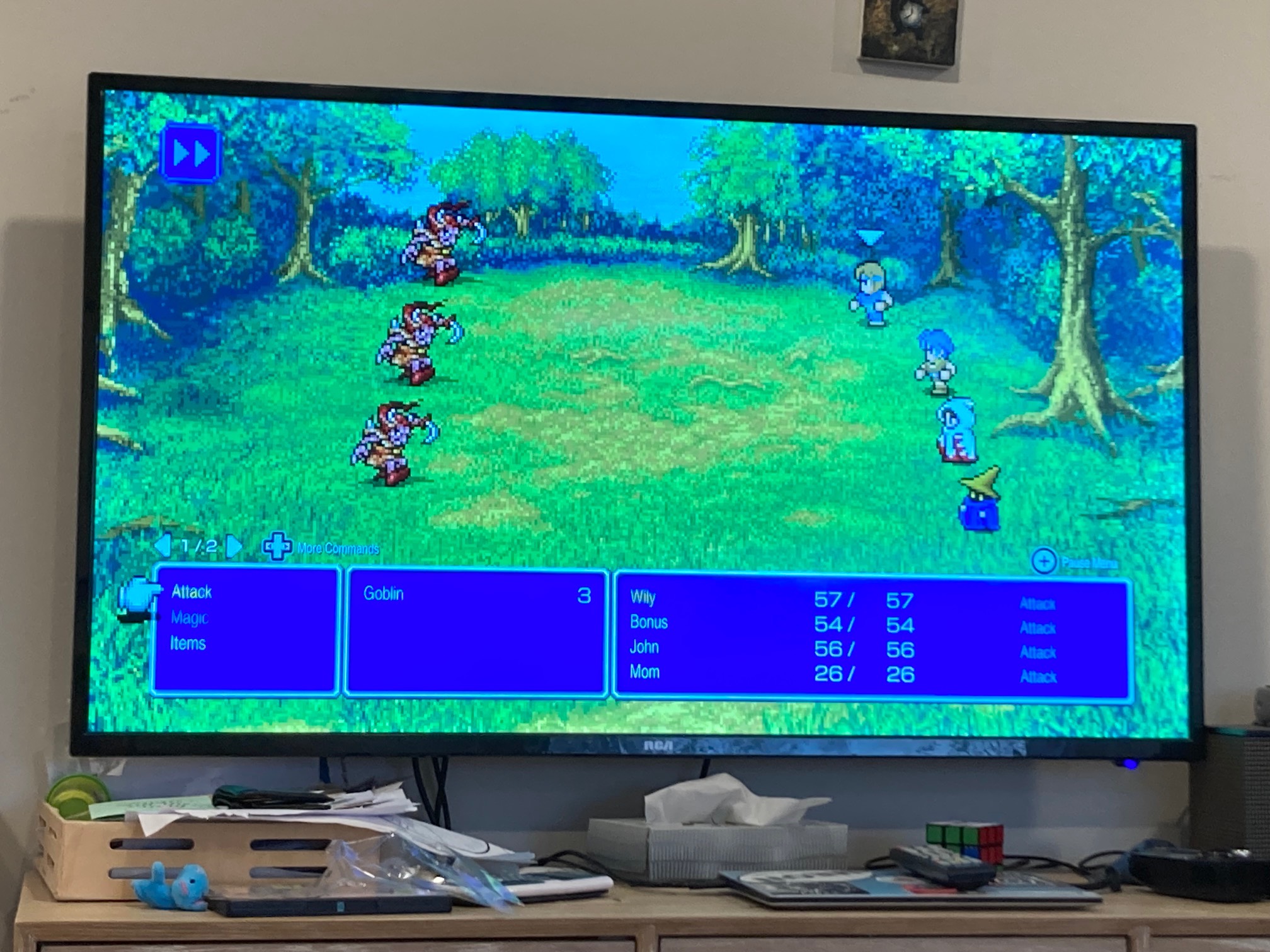 Imps and PCs on a green field on a TV