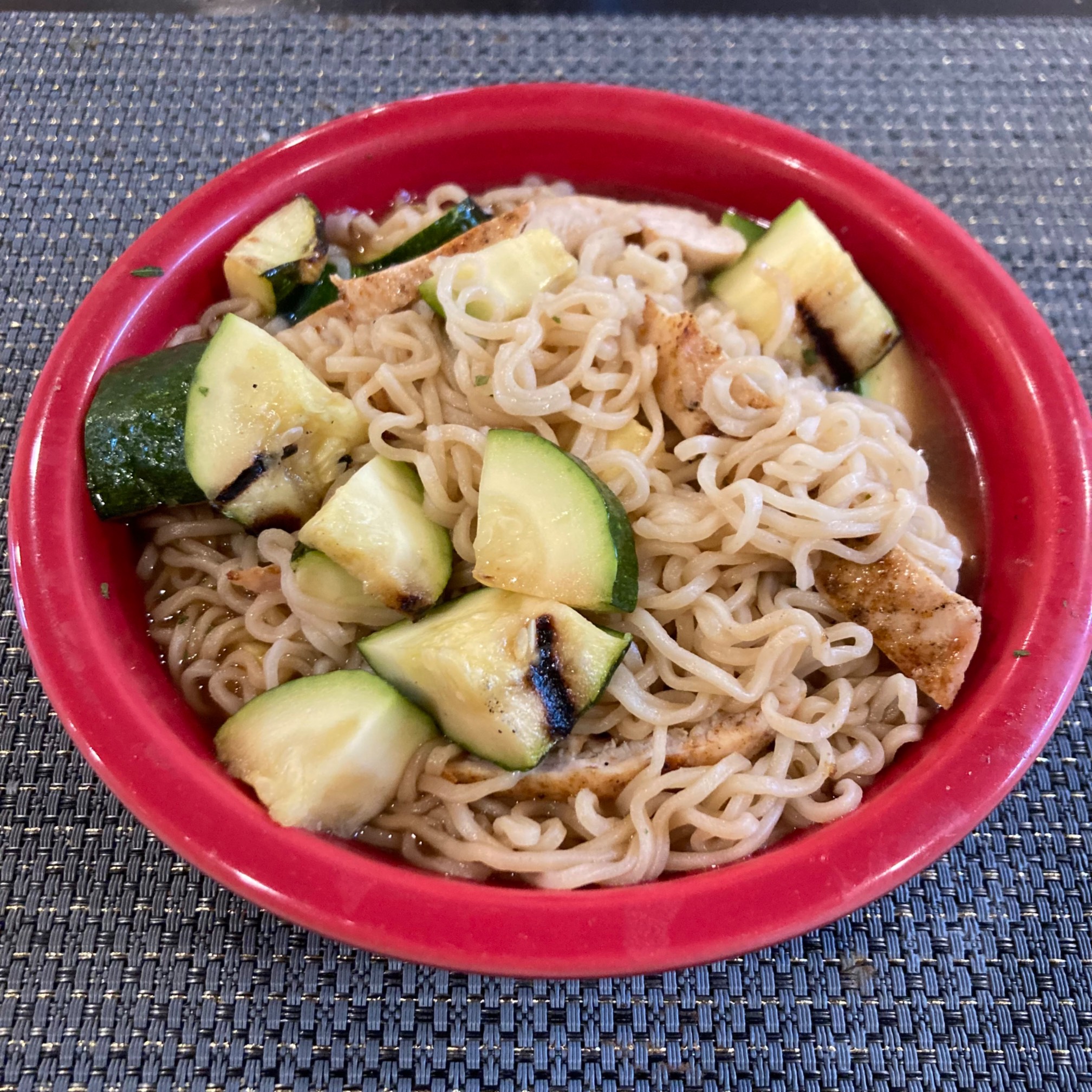 Ramen with chicken and zucchini on it