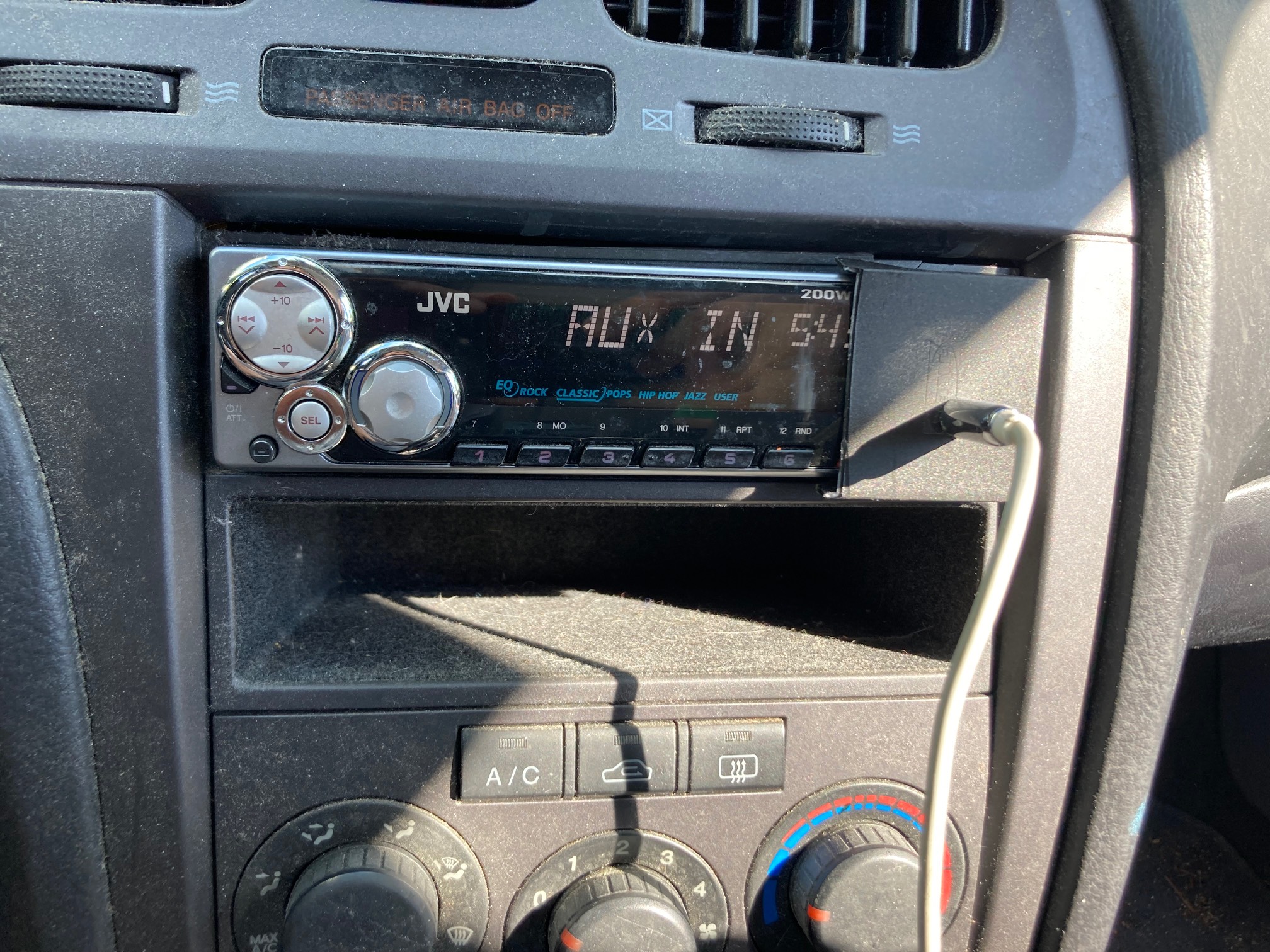 Car stereo with plastic plate over one side
