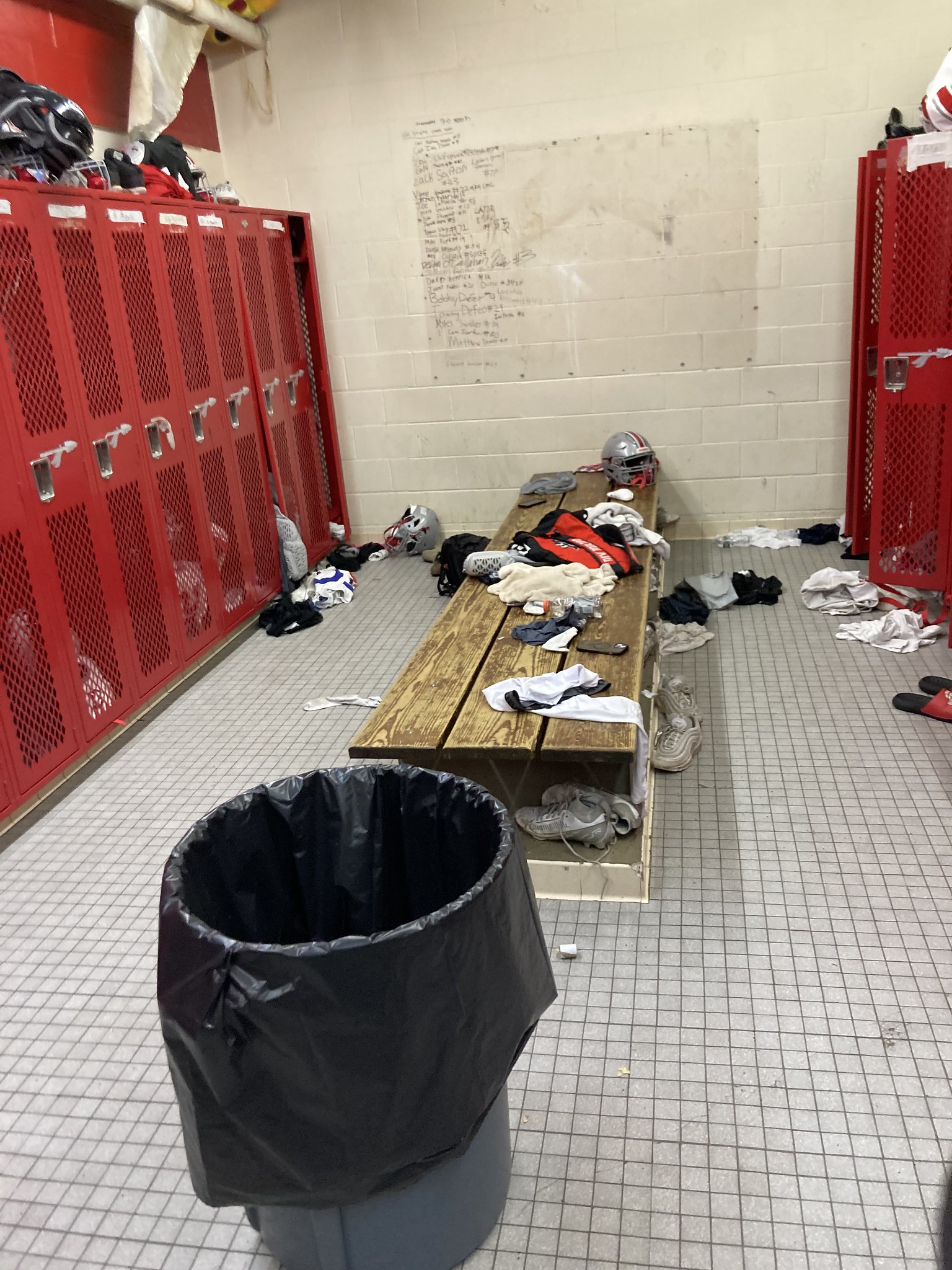 Locker room with clothes strewn about