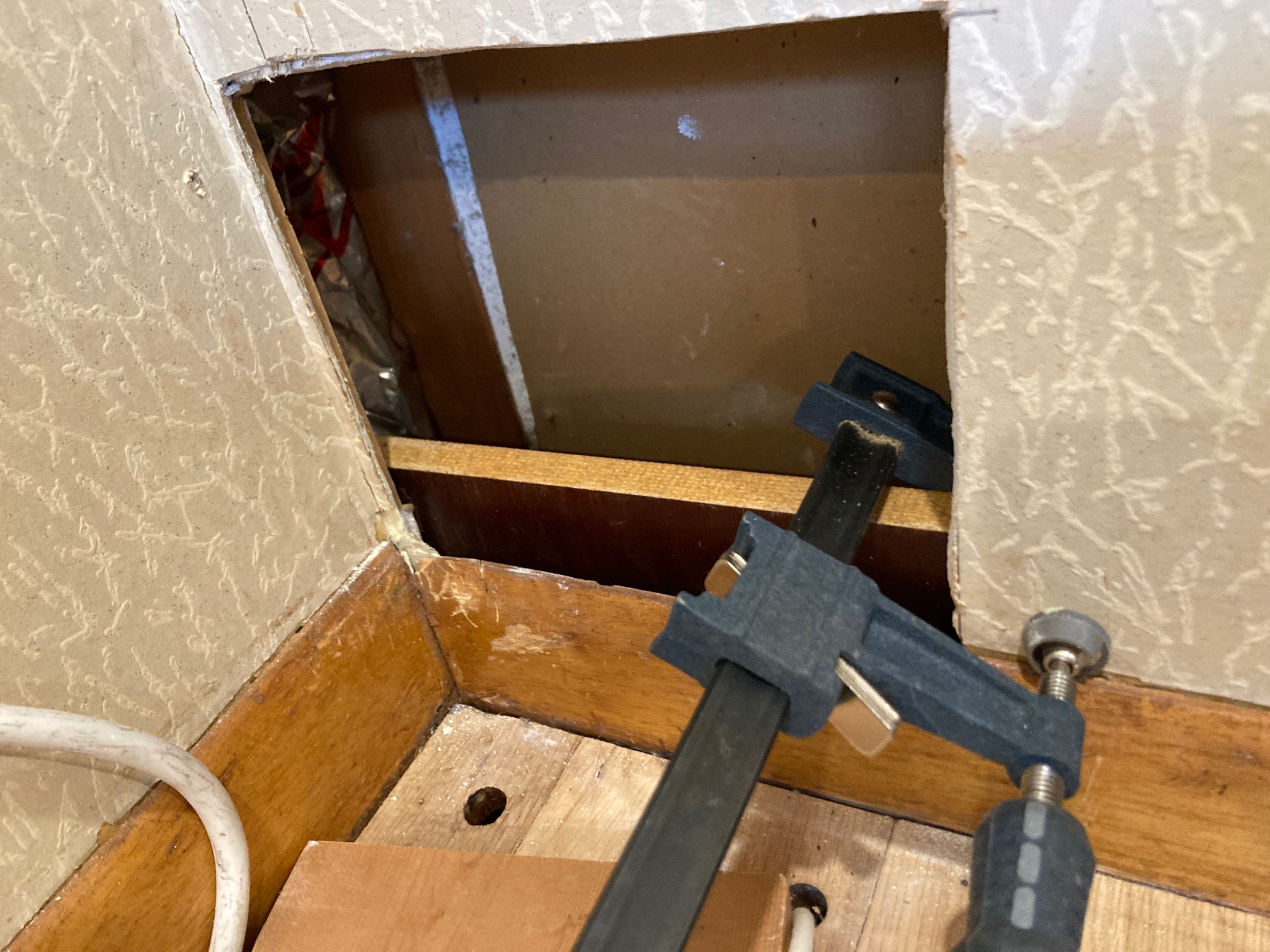 Board in drywall hole with clamp