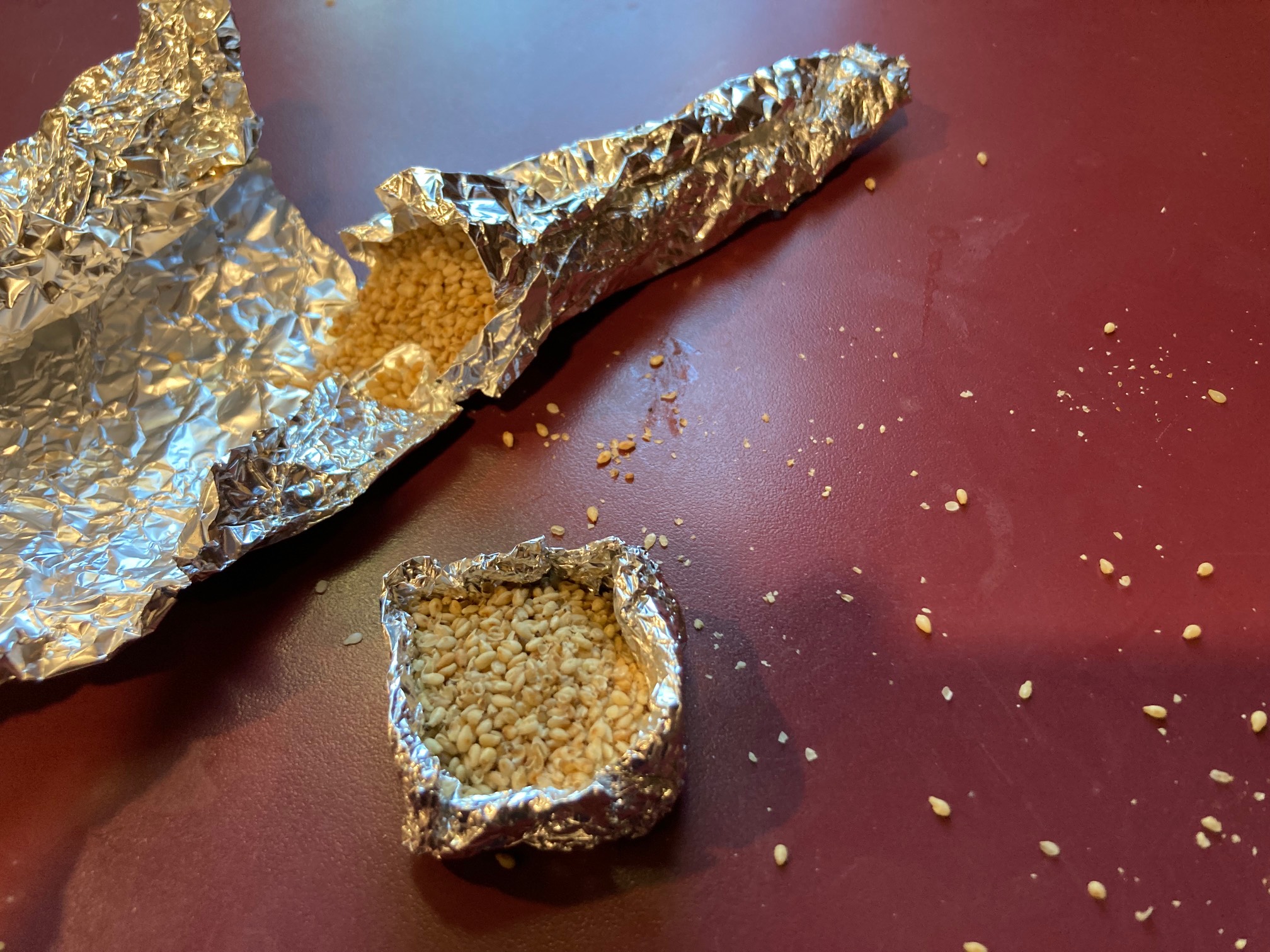 A foil box and a foil cone filled sesame seeds
