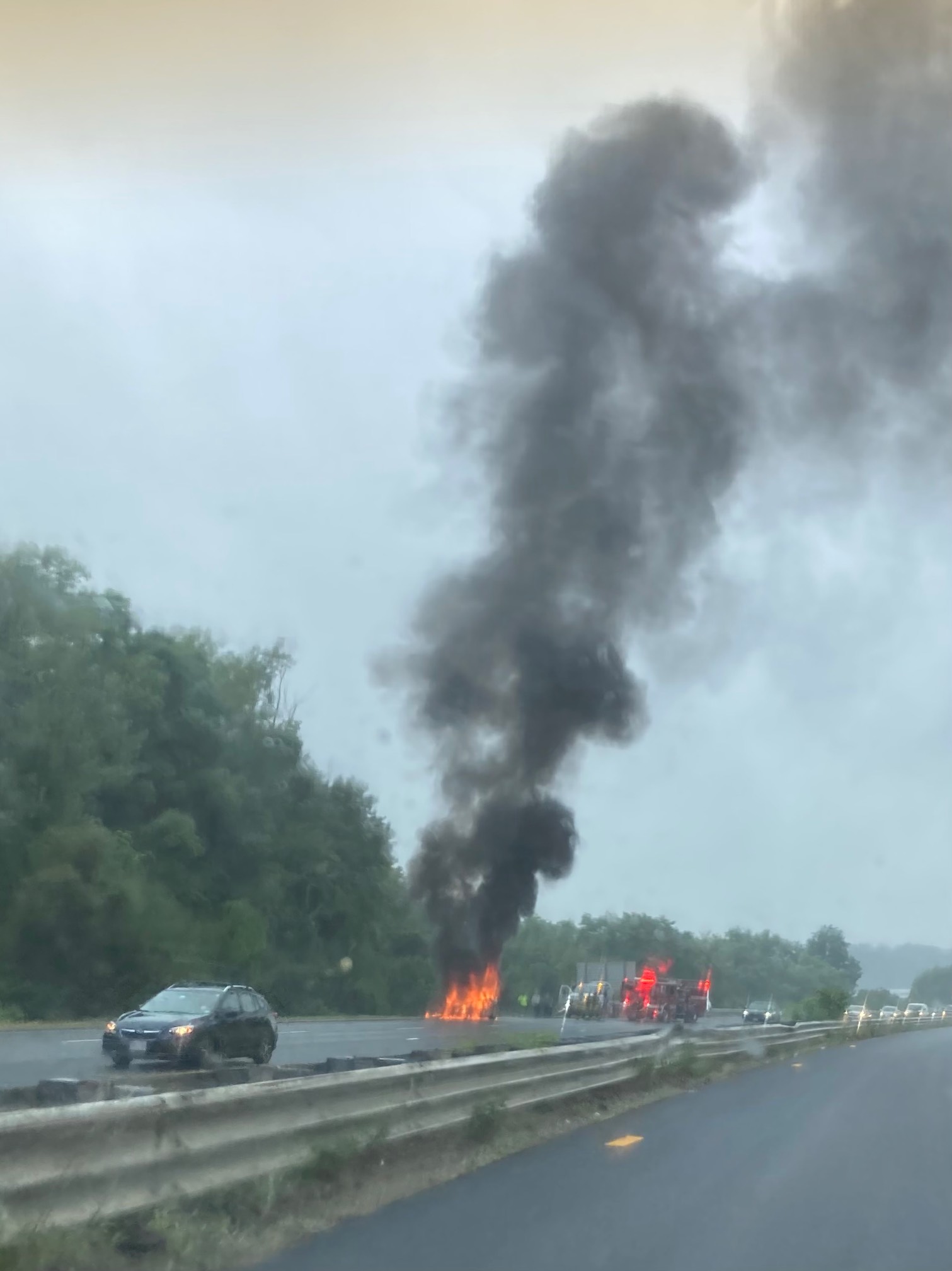 Car on fire on side of expressway