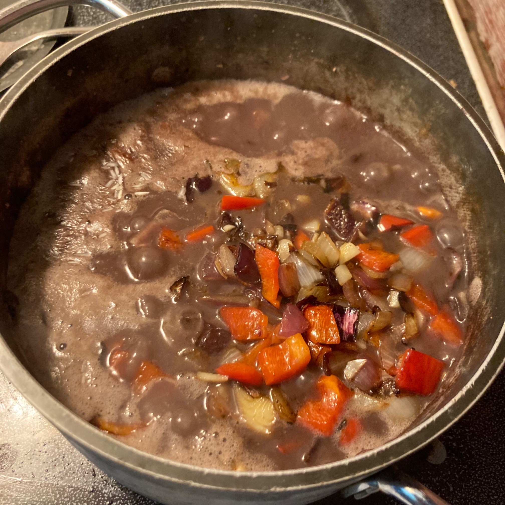 Rice, peppers, onions, and beans in a pot
