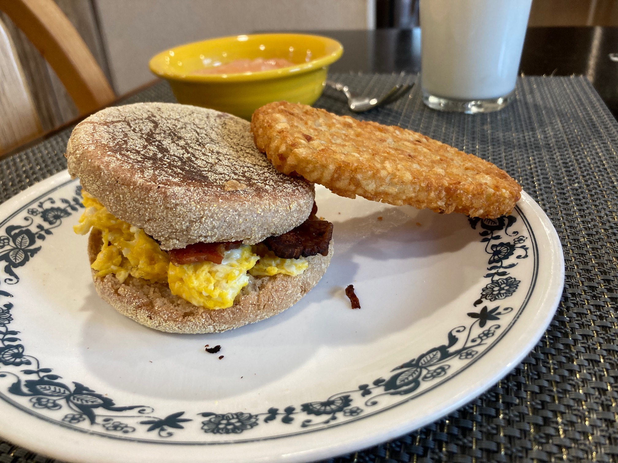 Hash brown leaning on sandwich and plate