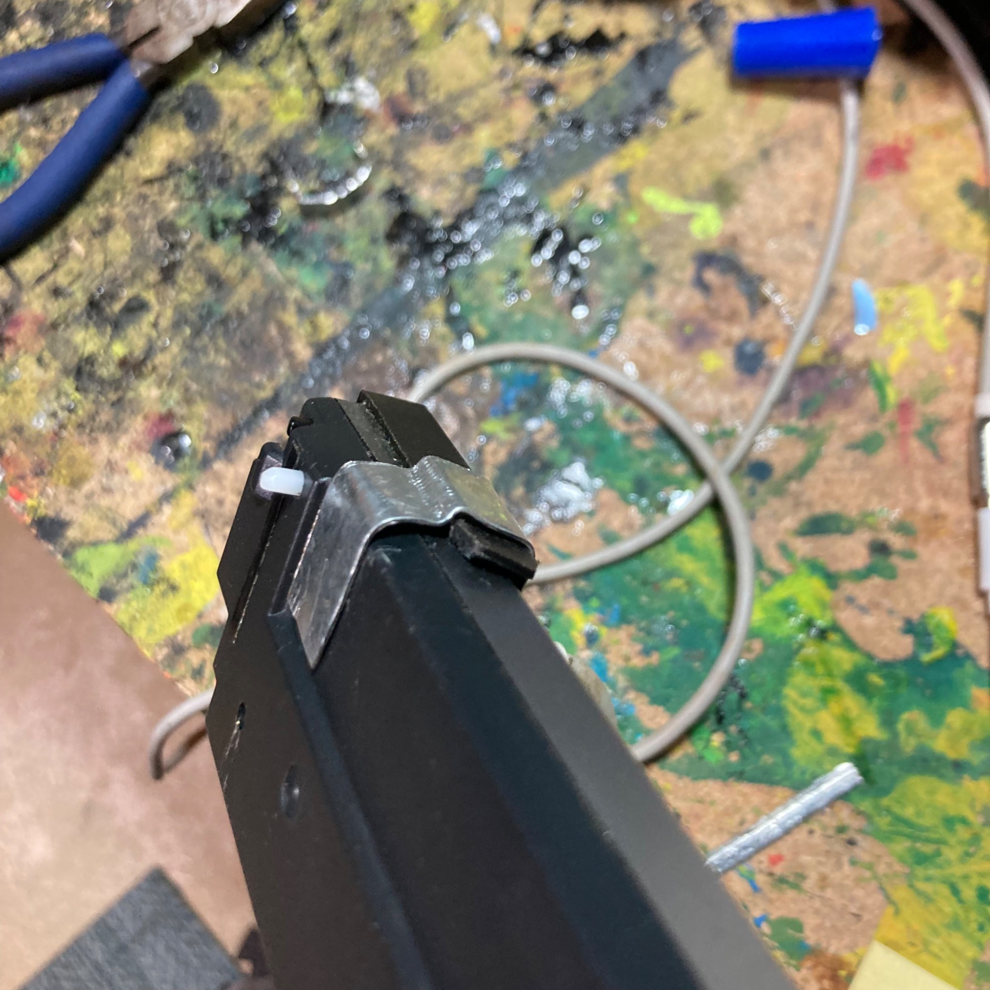 Strip of sheet metal being bent into a U-shaped clip fitting to a car stereo face