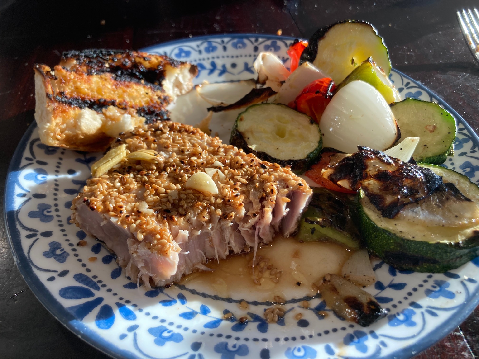 Plate with tuna, garlic bread, and grilled vegetables