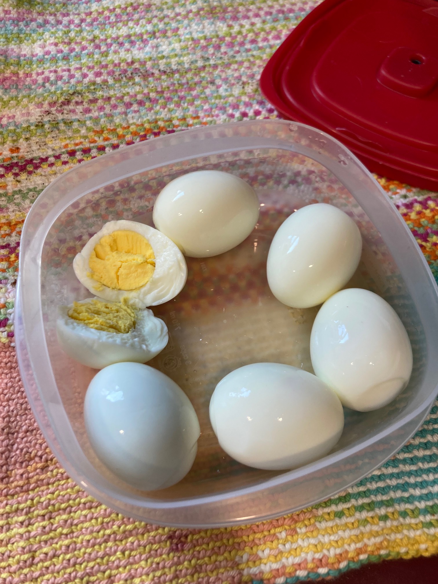 Six boiled eggs, one split in half
