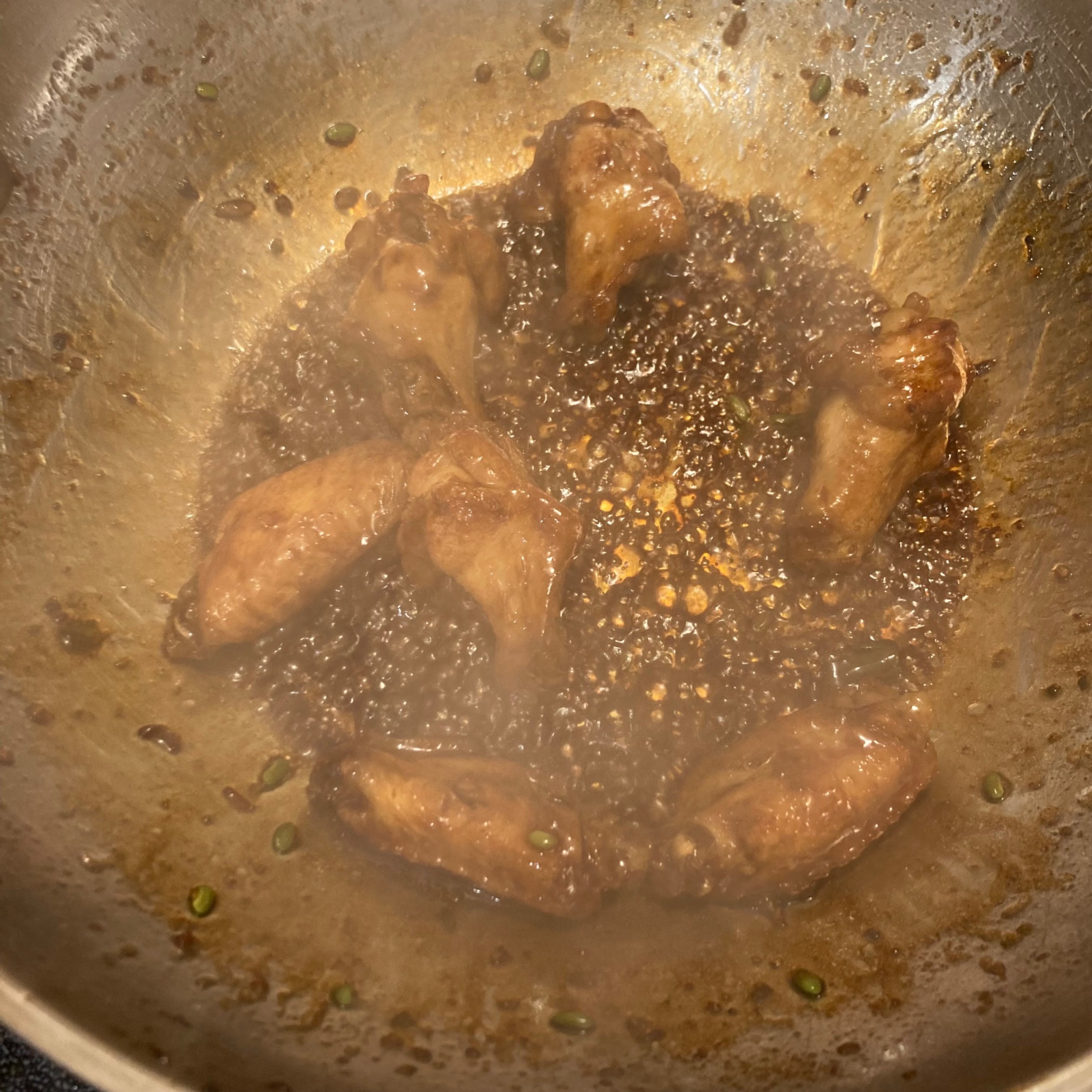 Wings frying in sauce