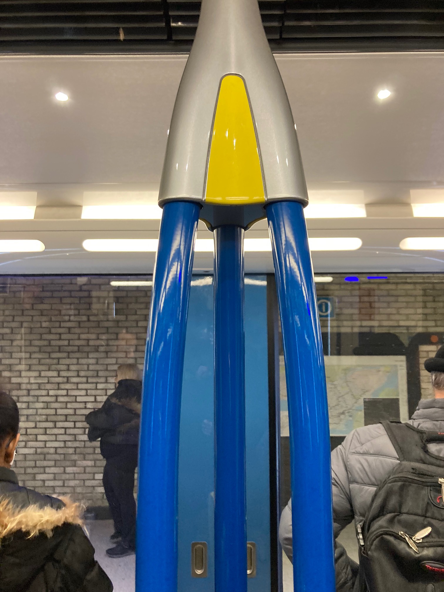 Three poles in a subway car