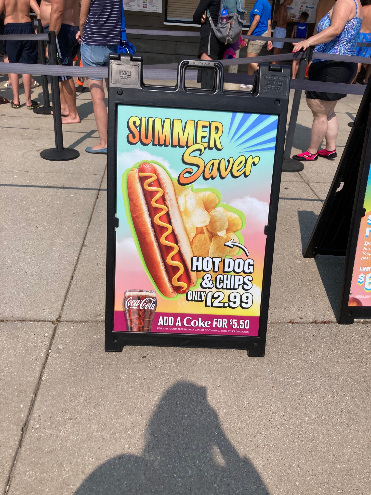 Sign for a $12.99 for hot dog and chips “deal” in a water park