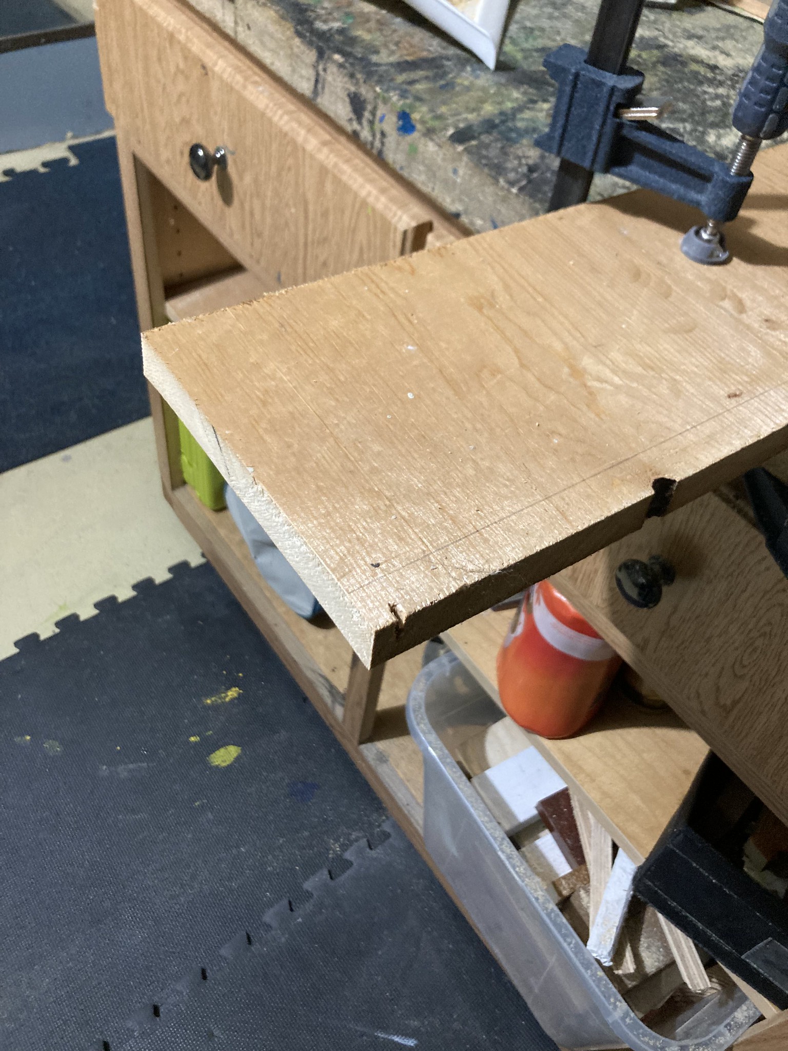 Cut board clamped to workbench