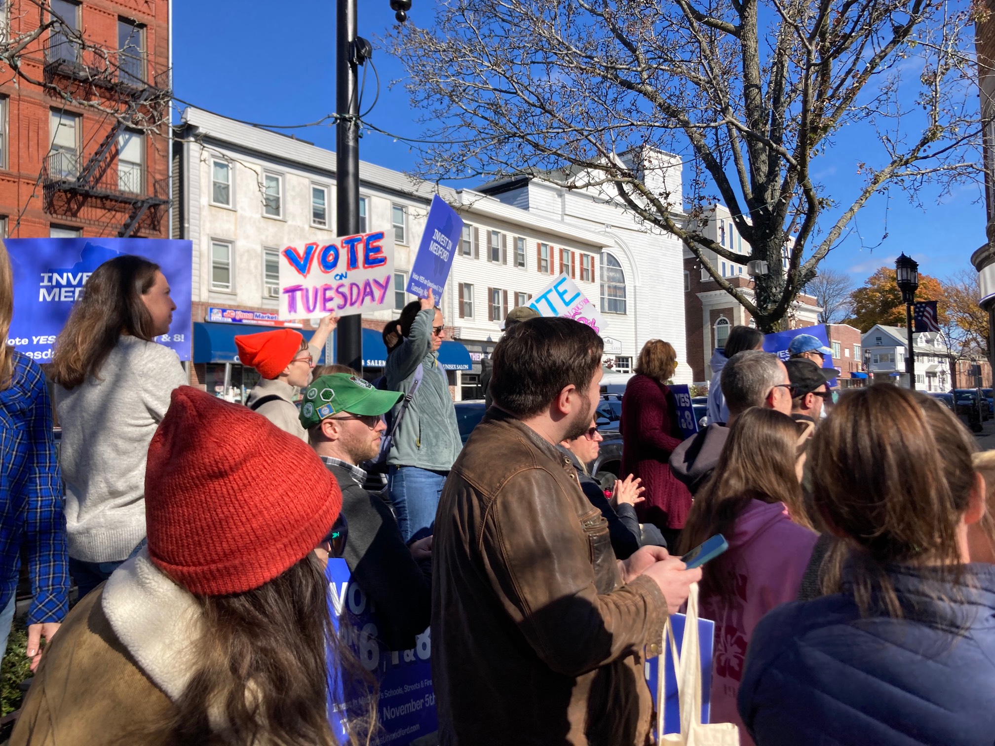 People watching a speech at a small rally