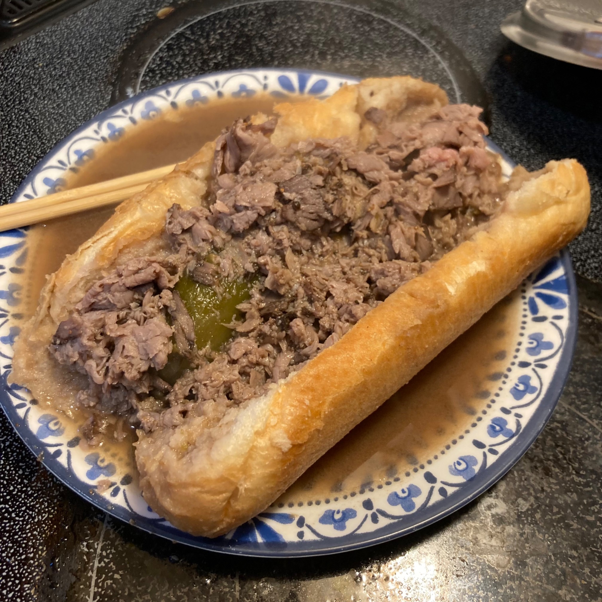 Italian beef sandwich with plate fill with juice