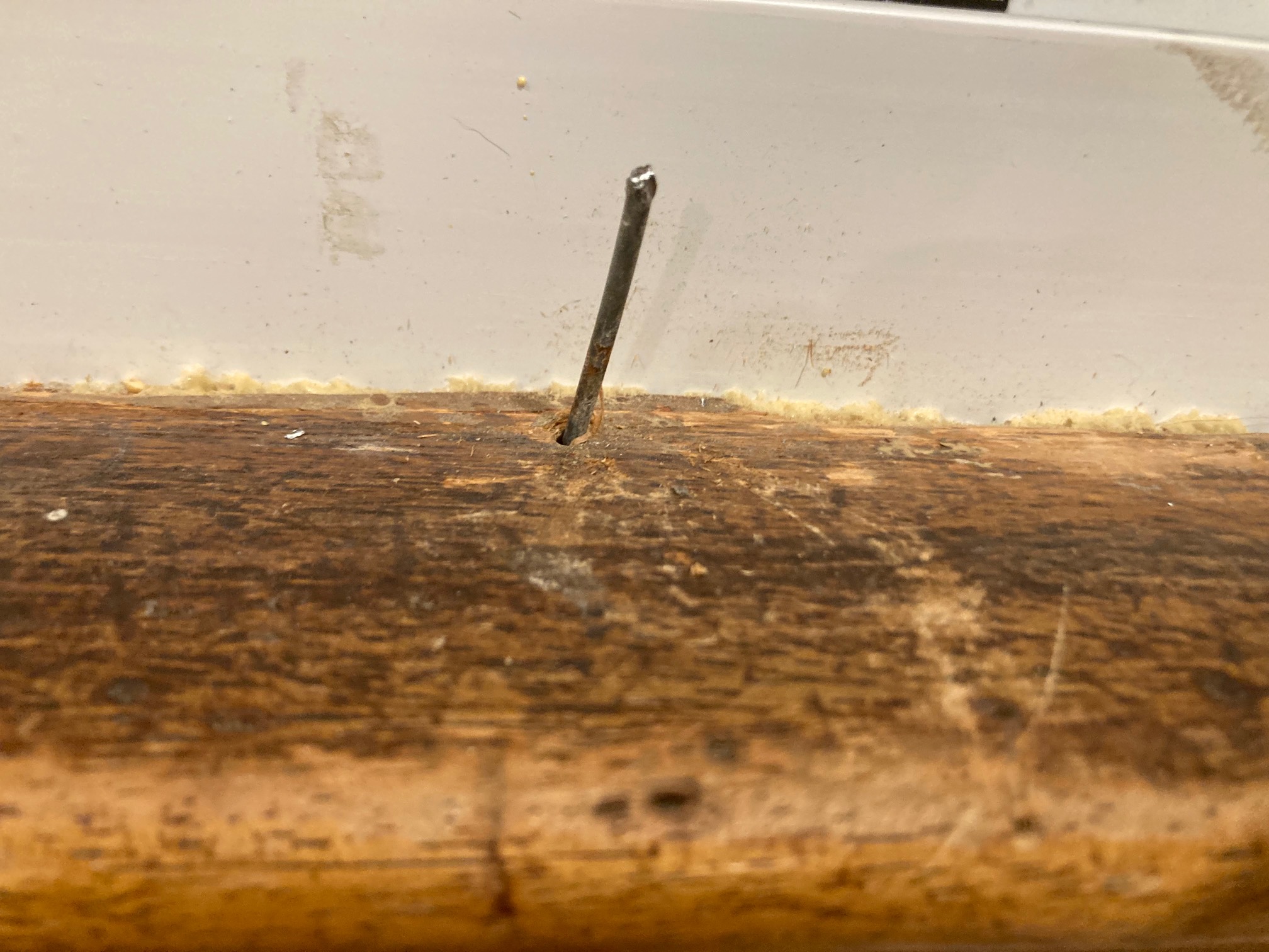 Window stool with headless nail in it