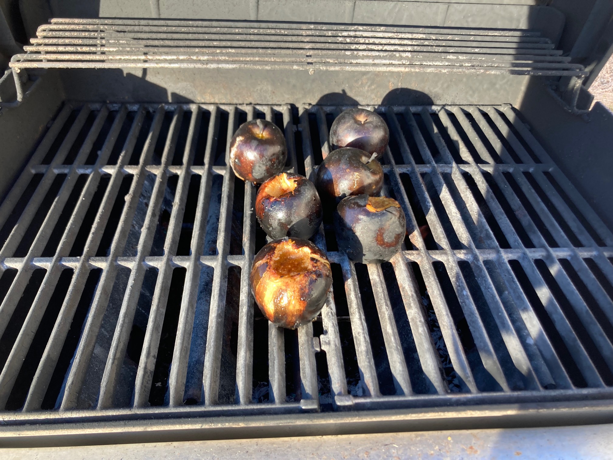 Apples with charred skin on grill