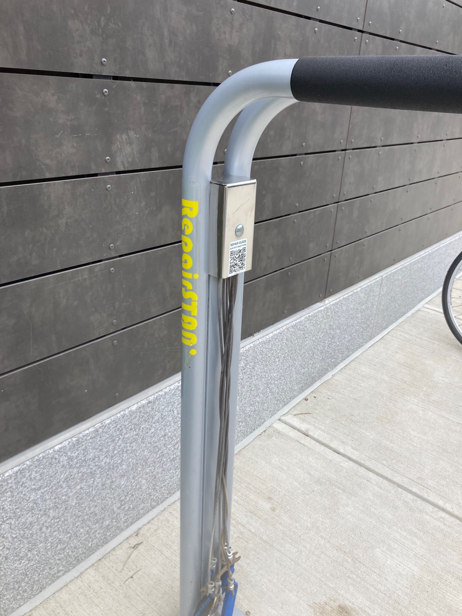 Bicycle repair stand that says Repairstan with the D scratched off