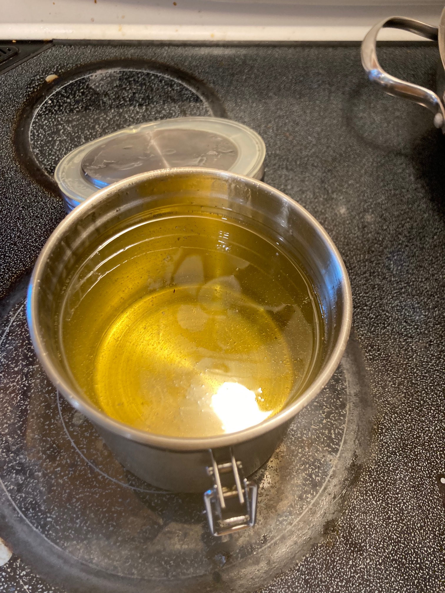 Open canister containing oil