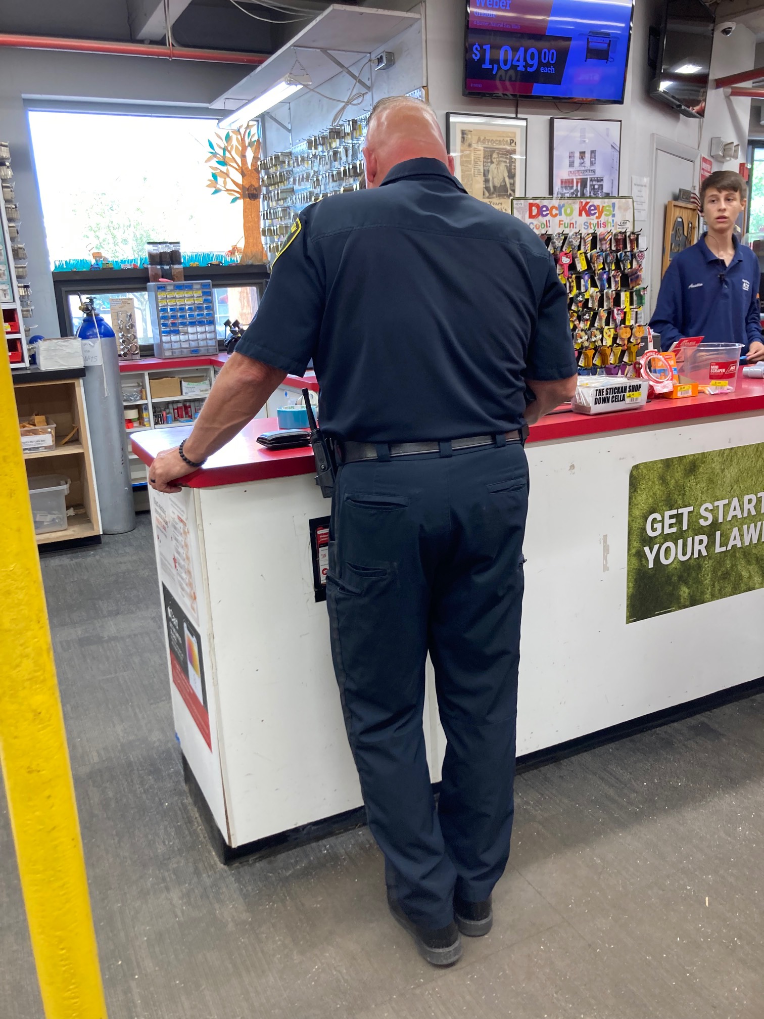 Bald man with red head at checkout counter