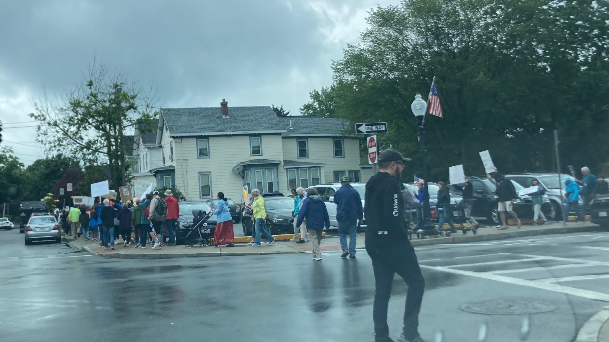 Protestors filing down a sidewalk
