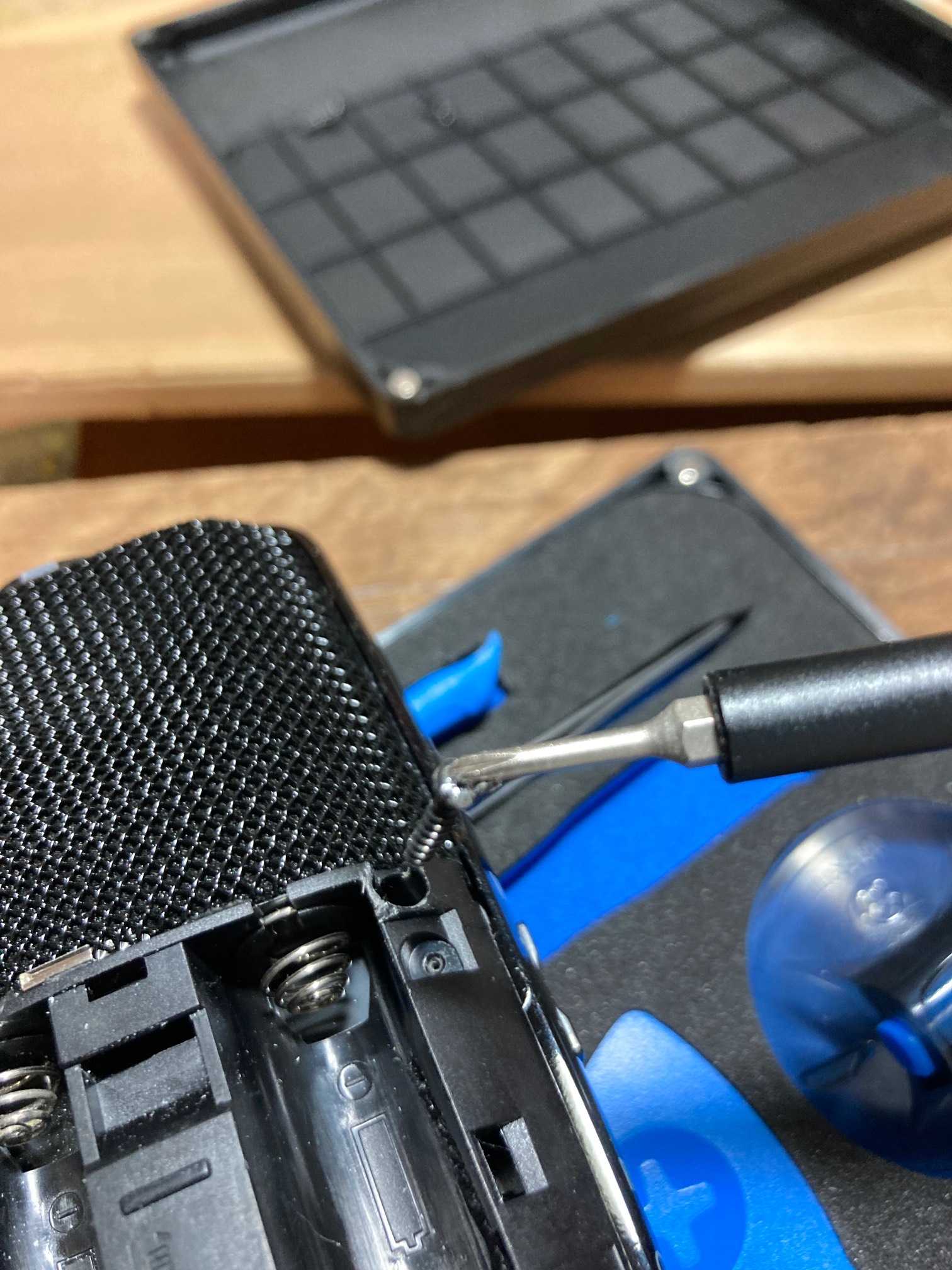 Handheld recorder and screwdriver holding a screw