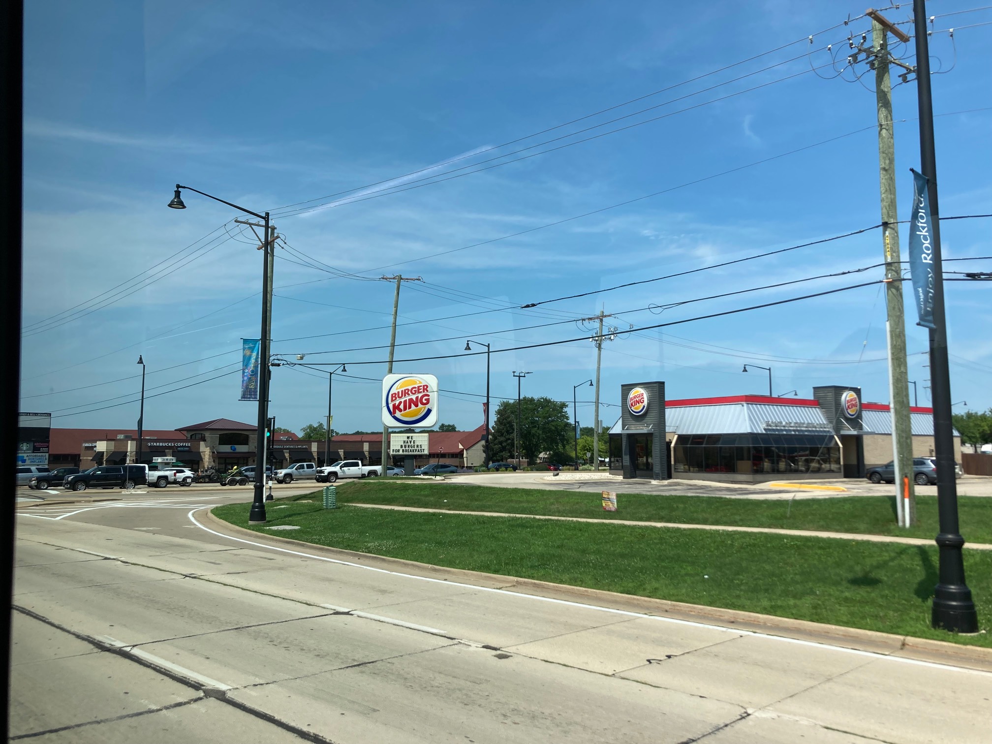 Intersection with Burger King sign that says “We have burgers for breakfast”