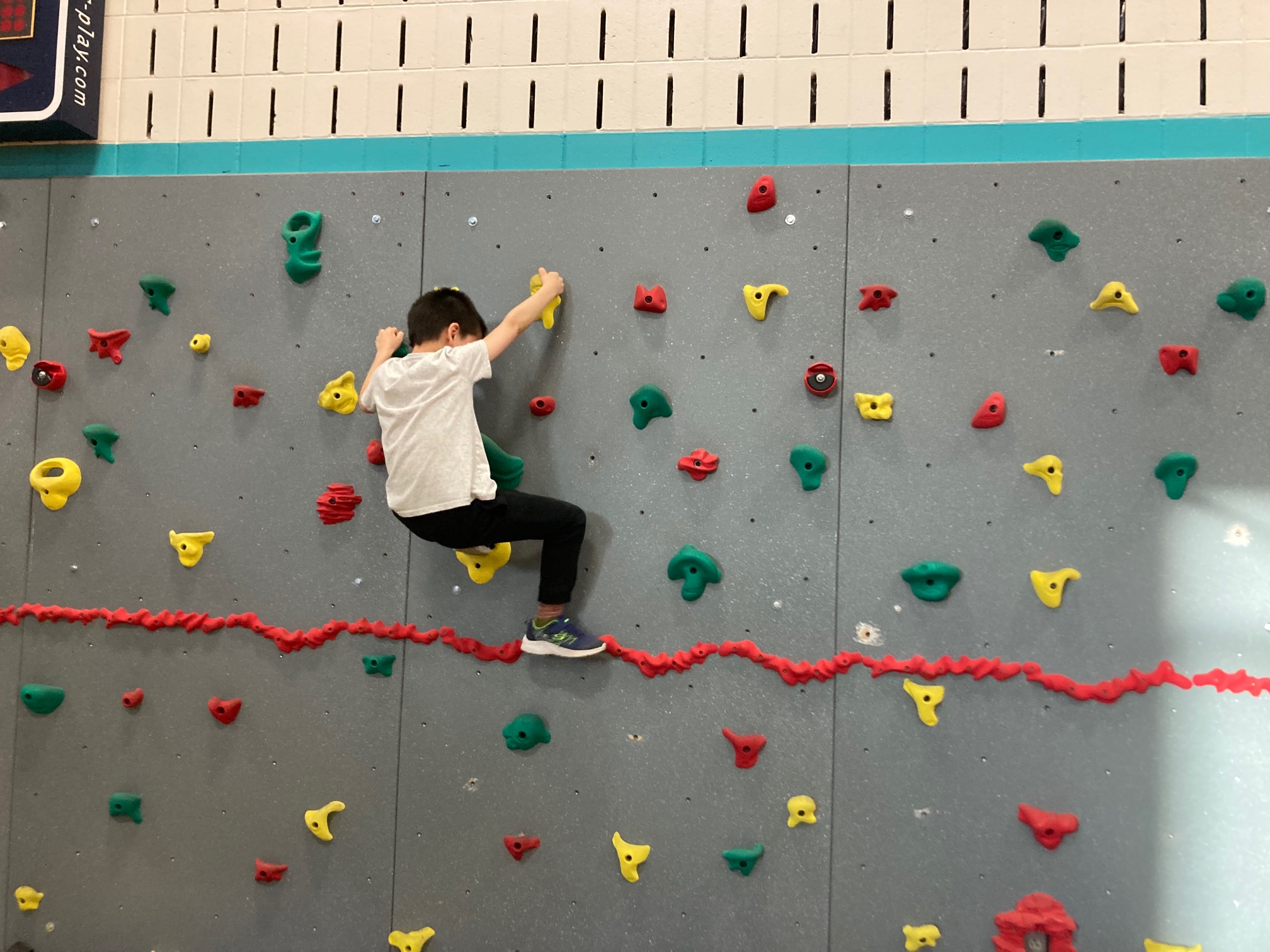 Kid on school climbing wall