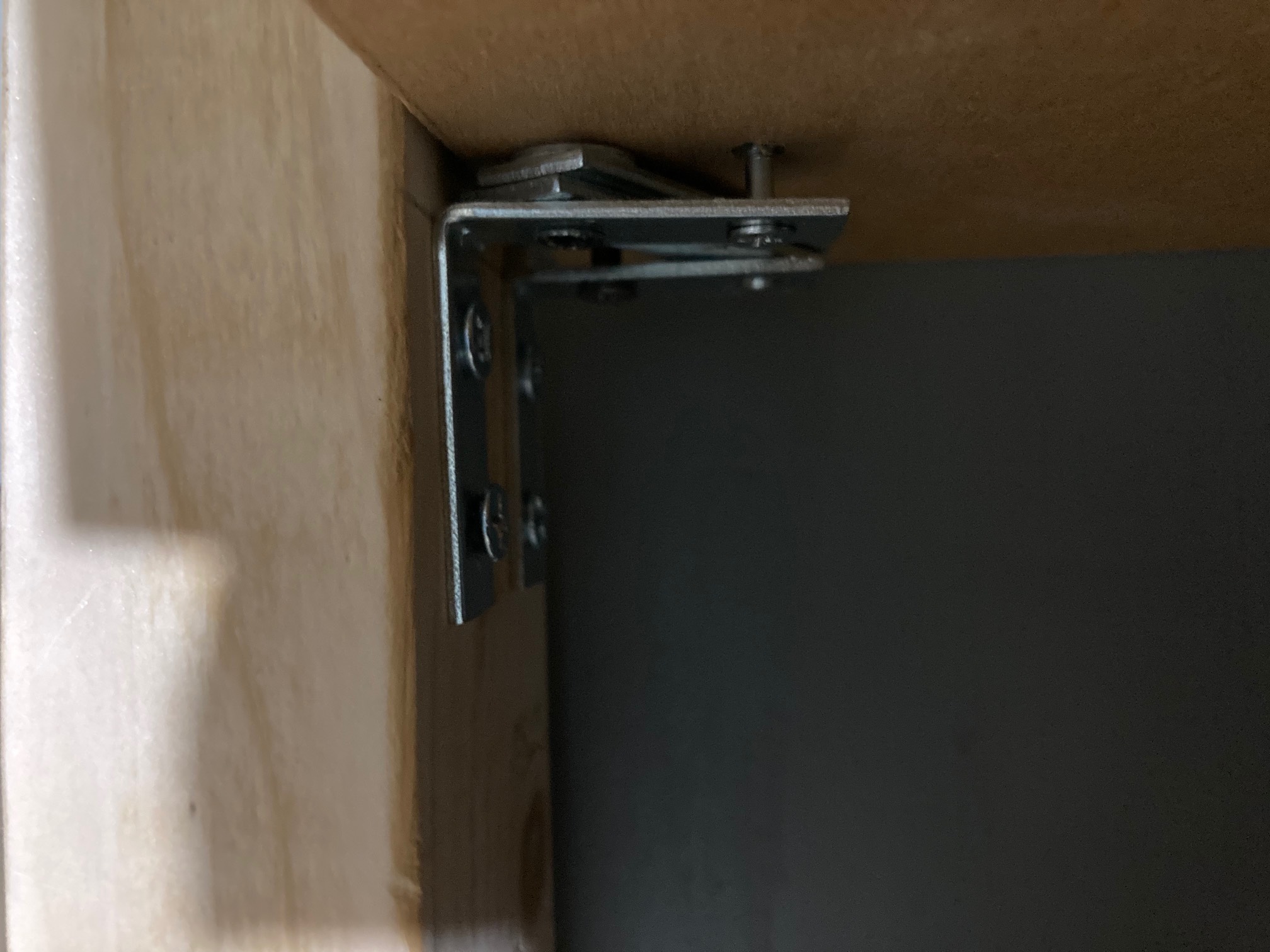I drilled two sets of holes into the studs because the first set did not yield a level shelf. The se