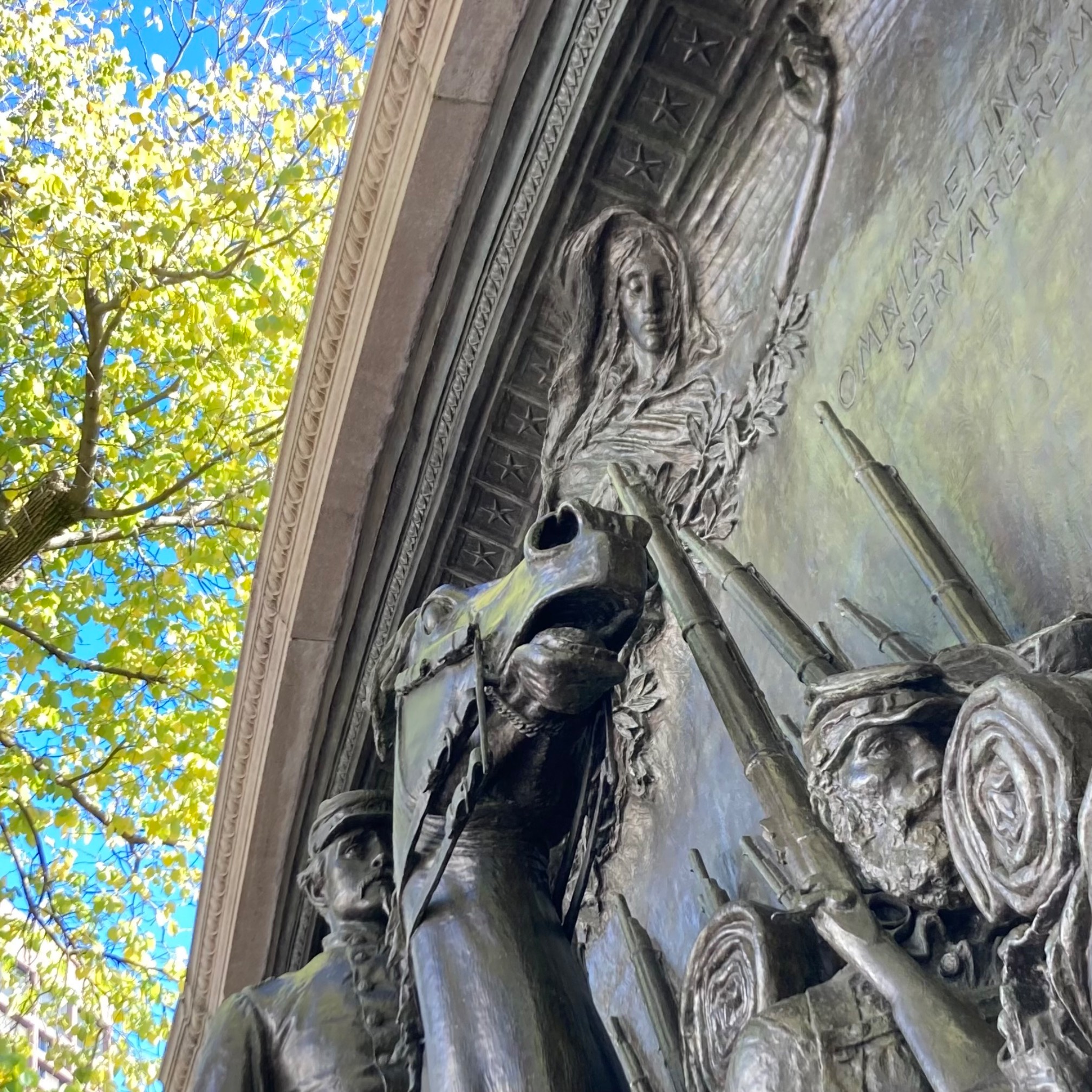 Bas relief sculpture of horse ridden by soldier with what appears to be a spirit above