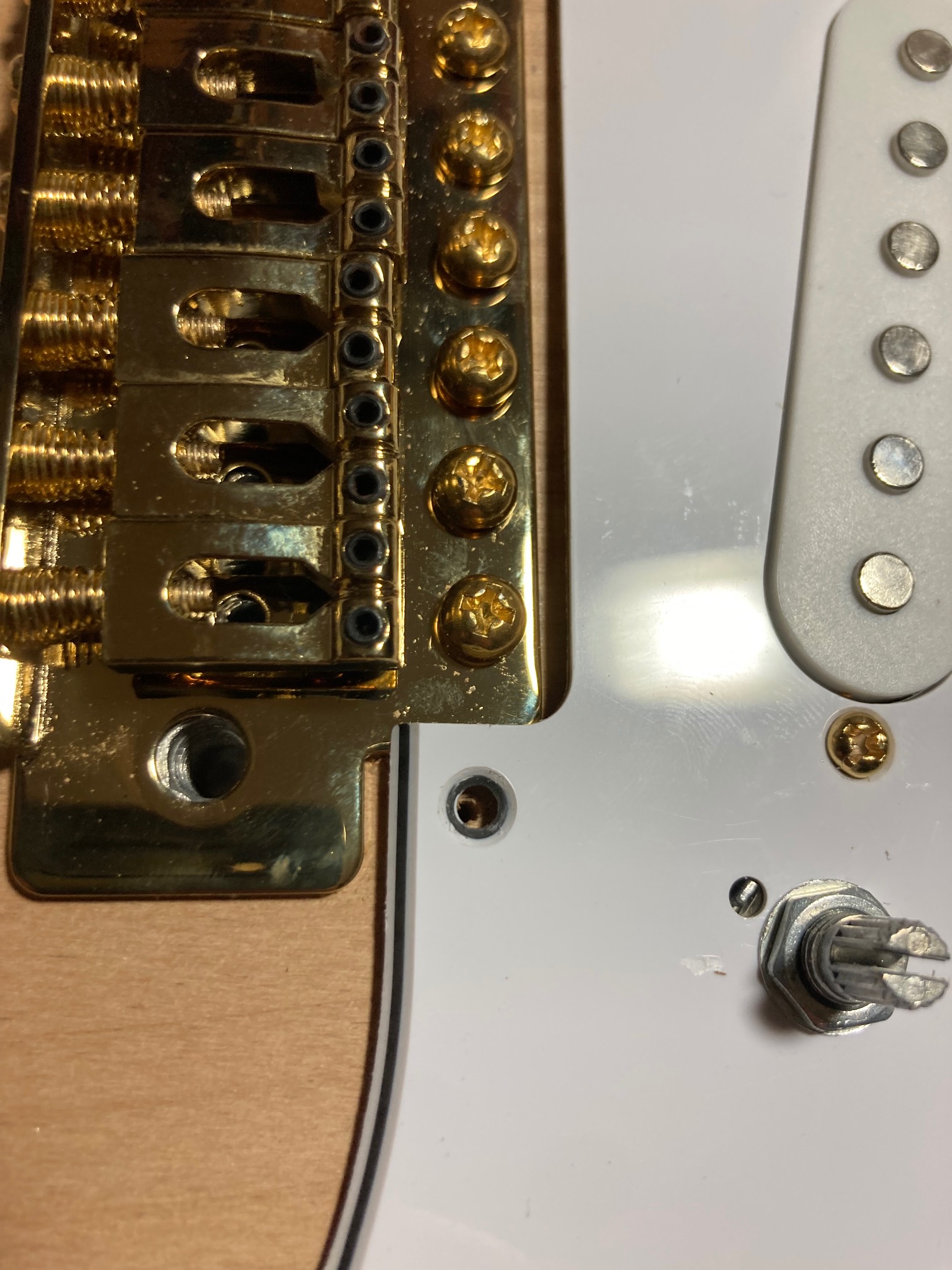 Drilled slightly off. I’m going to have to saw off a bit of this pickguard later.