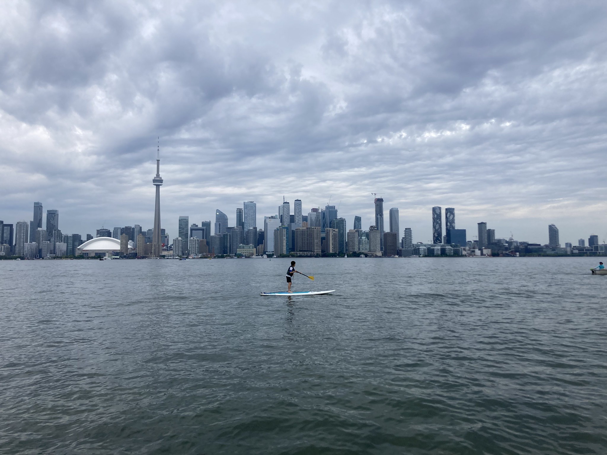 Kid on paddleboard in front of city skyline