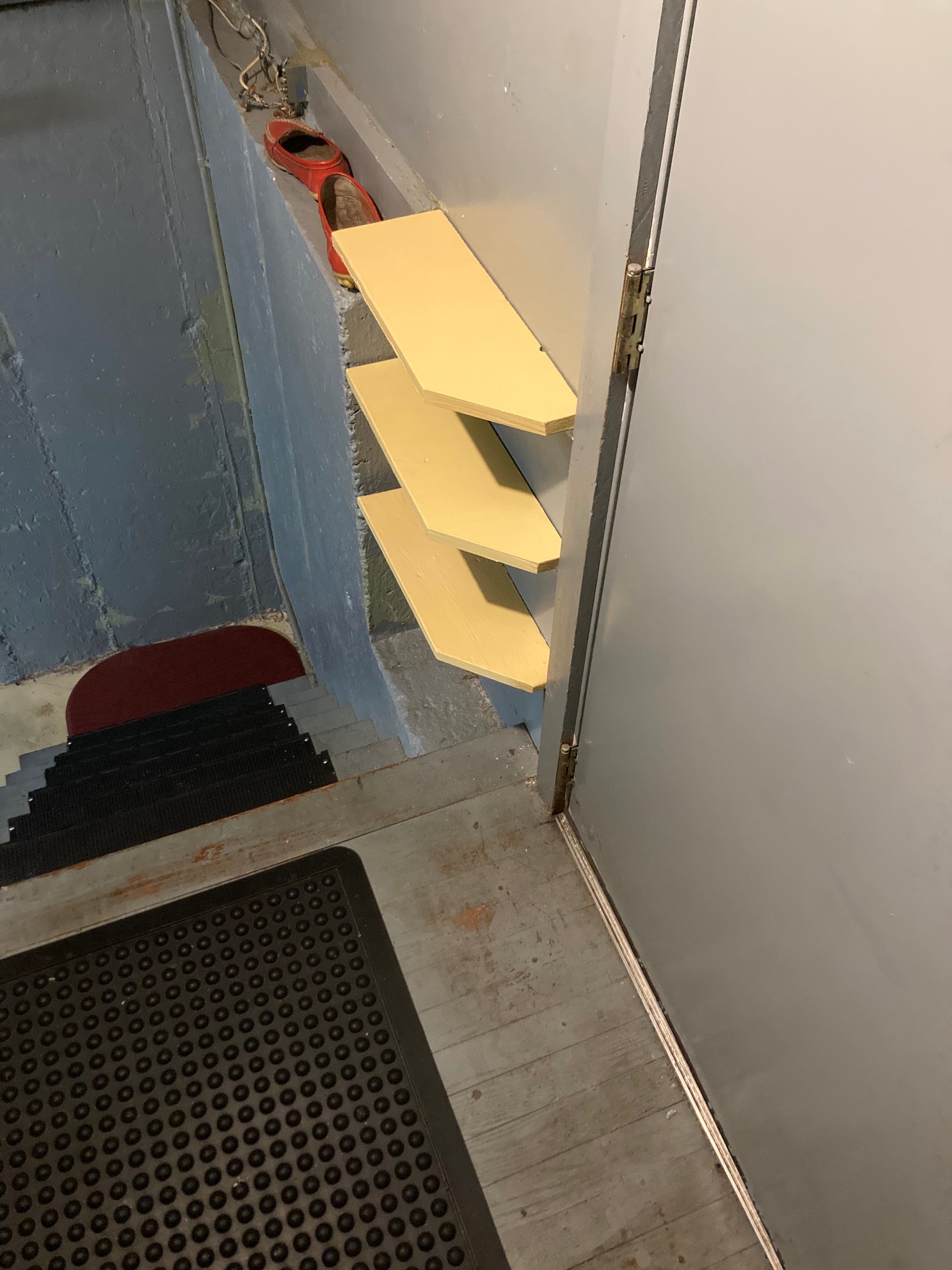 Yellow boards attached to wall in stairwau