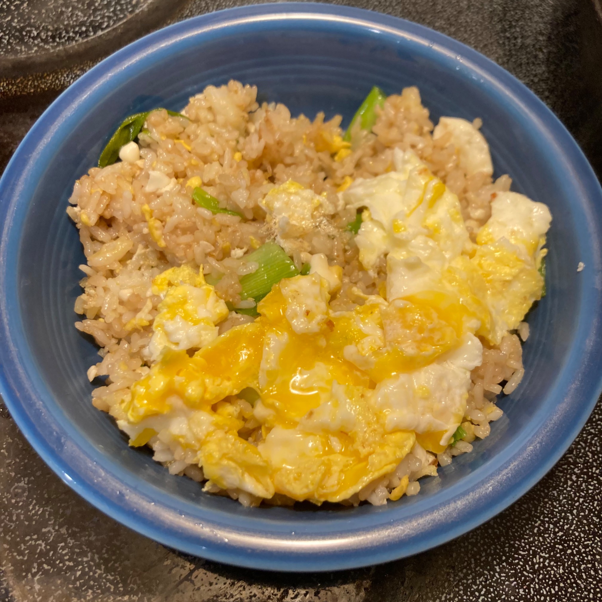 Bowl of fried rice with scallions and egg