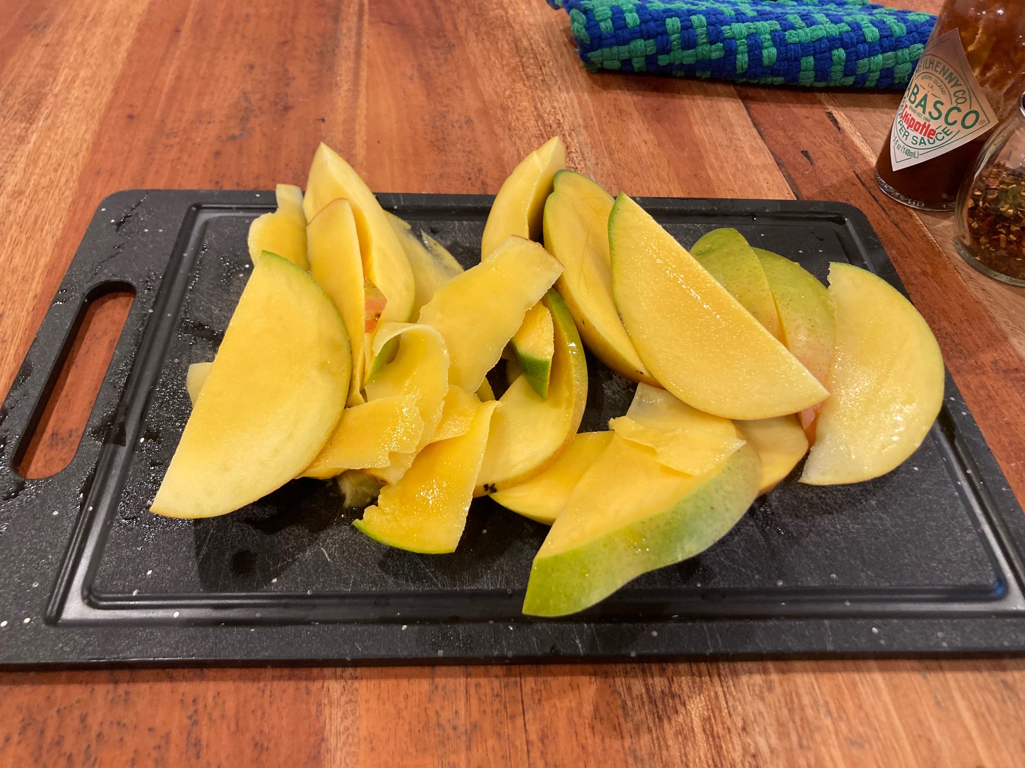 Sliced mango on cutting board