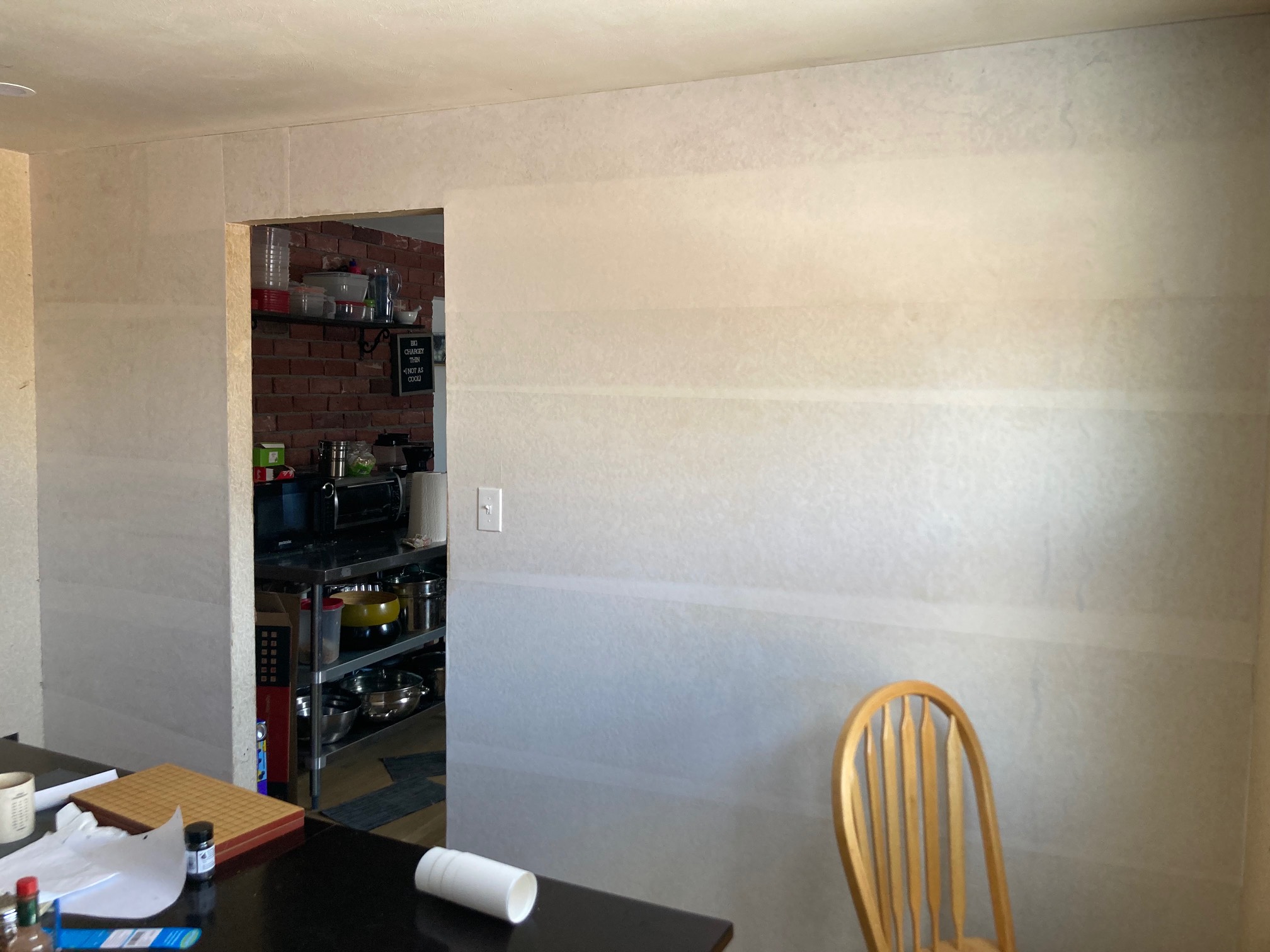 Wall covered with white paper with doorway in it