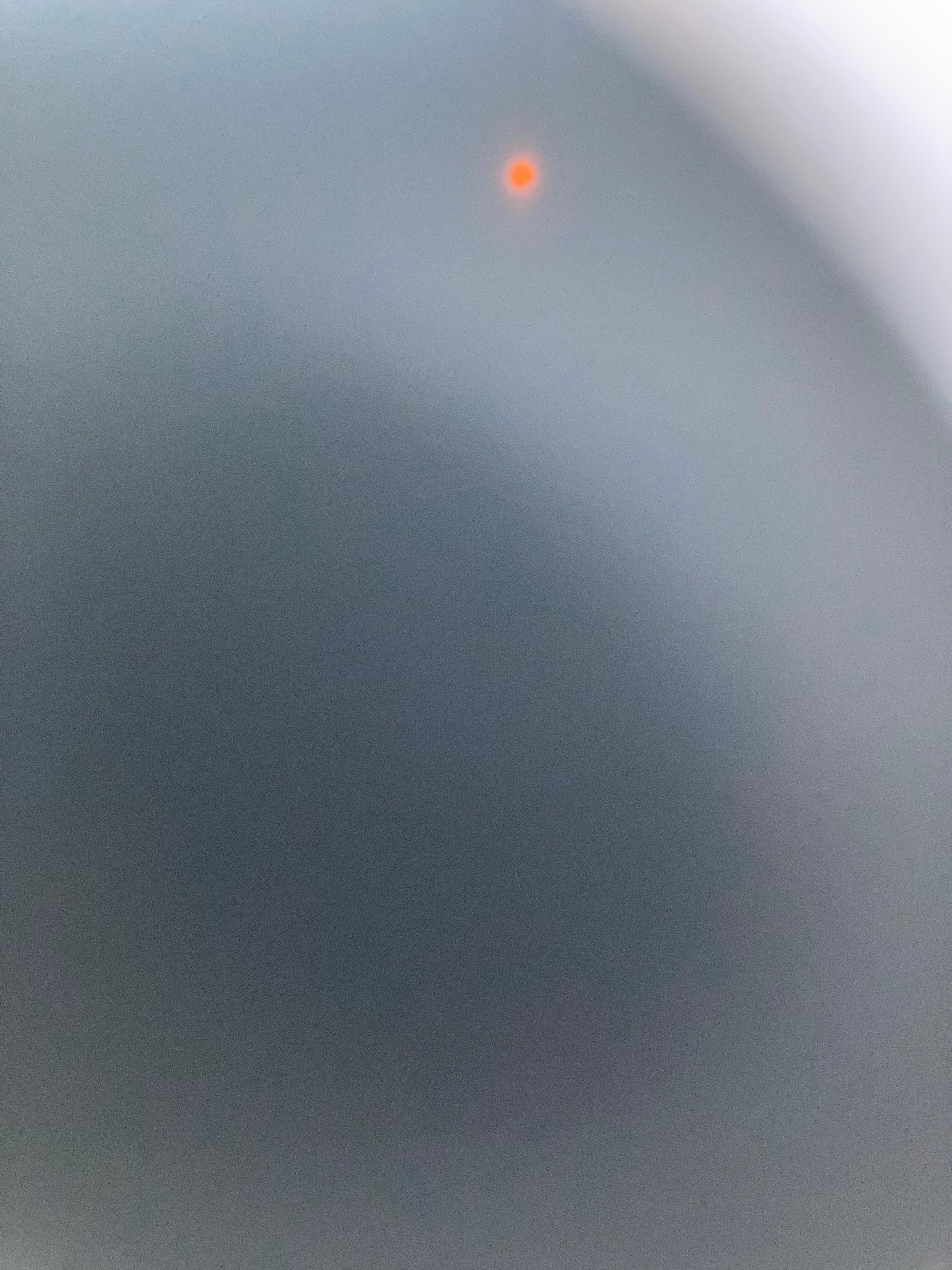 Let’s blindly try to take pictures of the eclipse by holding eclipse glasses against the phone, why not
