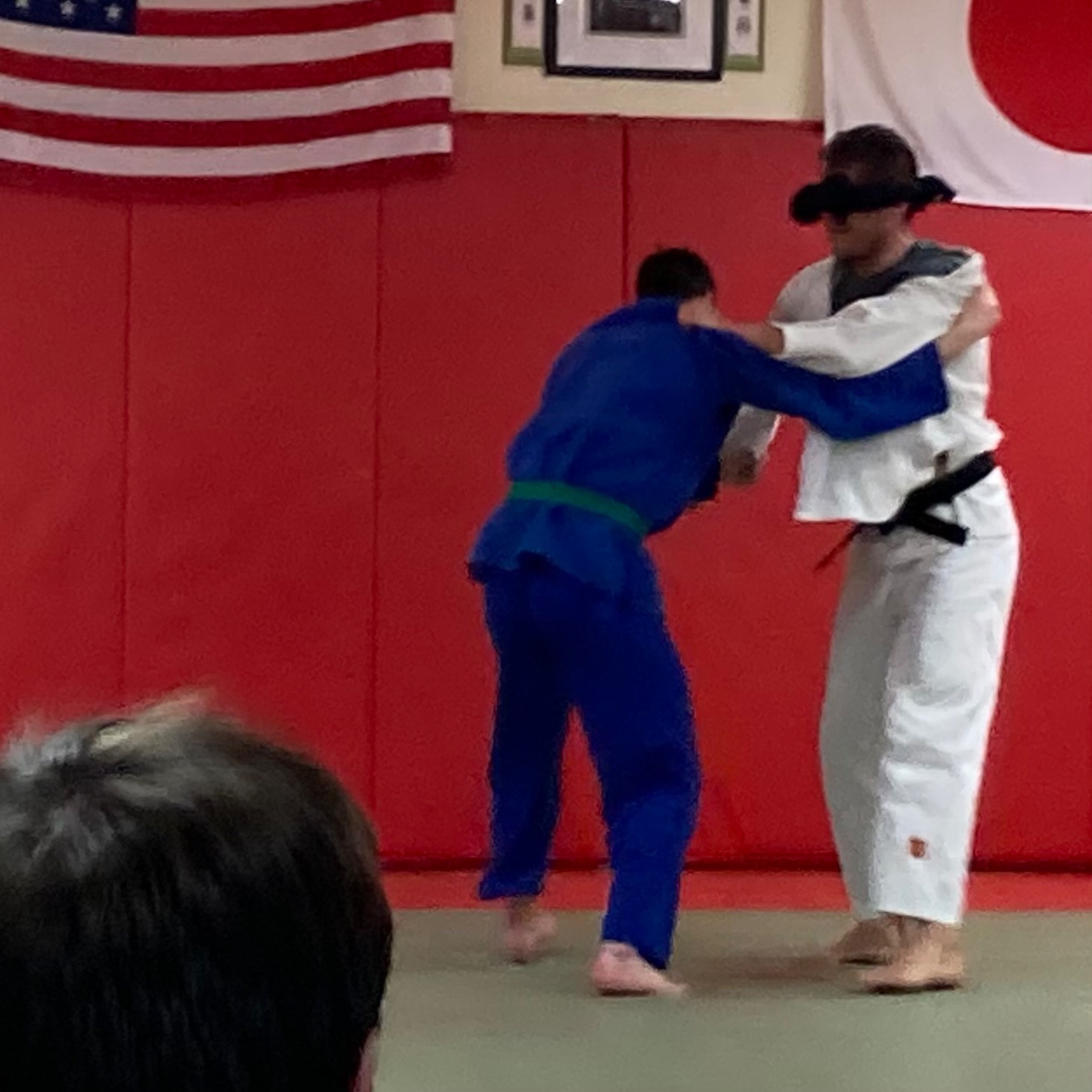 Blindfolded man fighting another guy without a blindfold