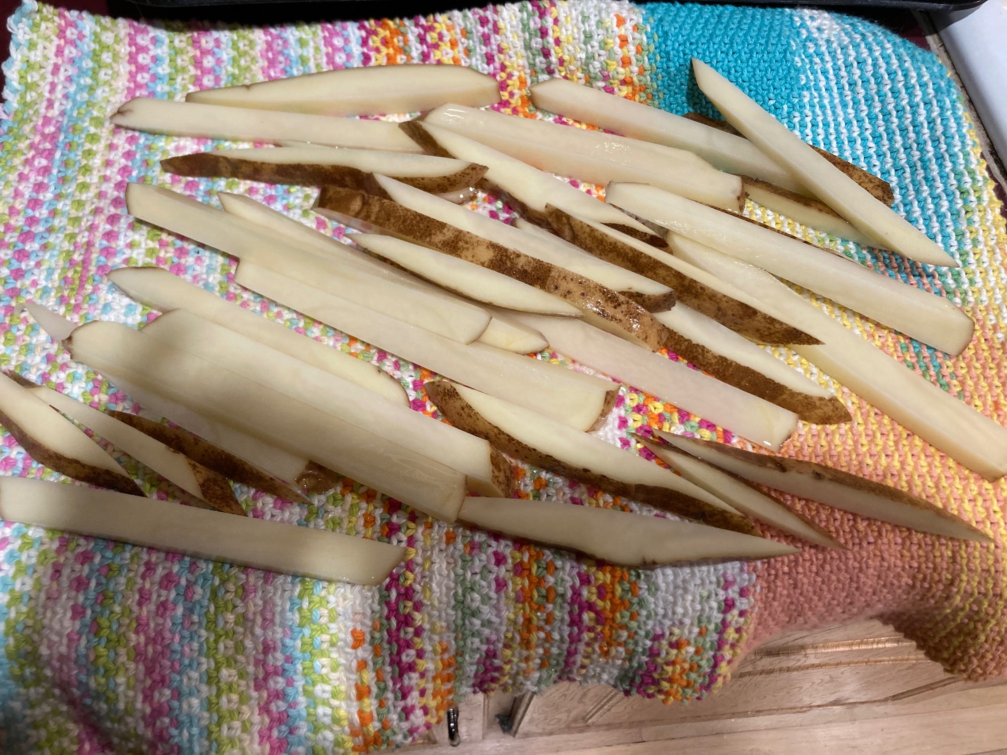 Slices of potato on a colorful knit mat