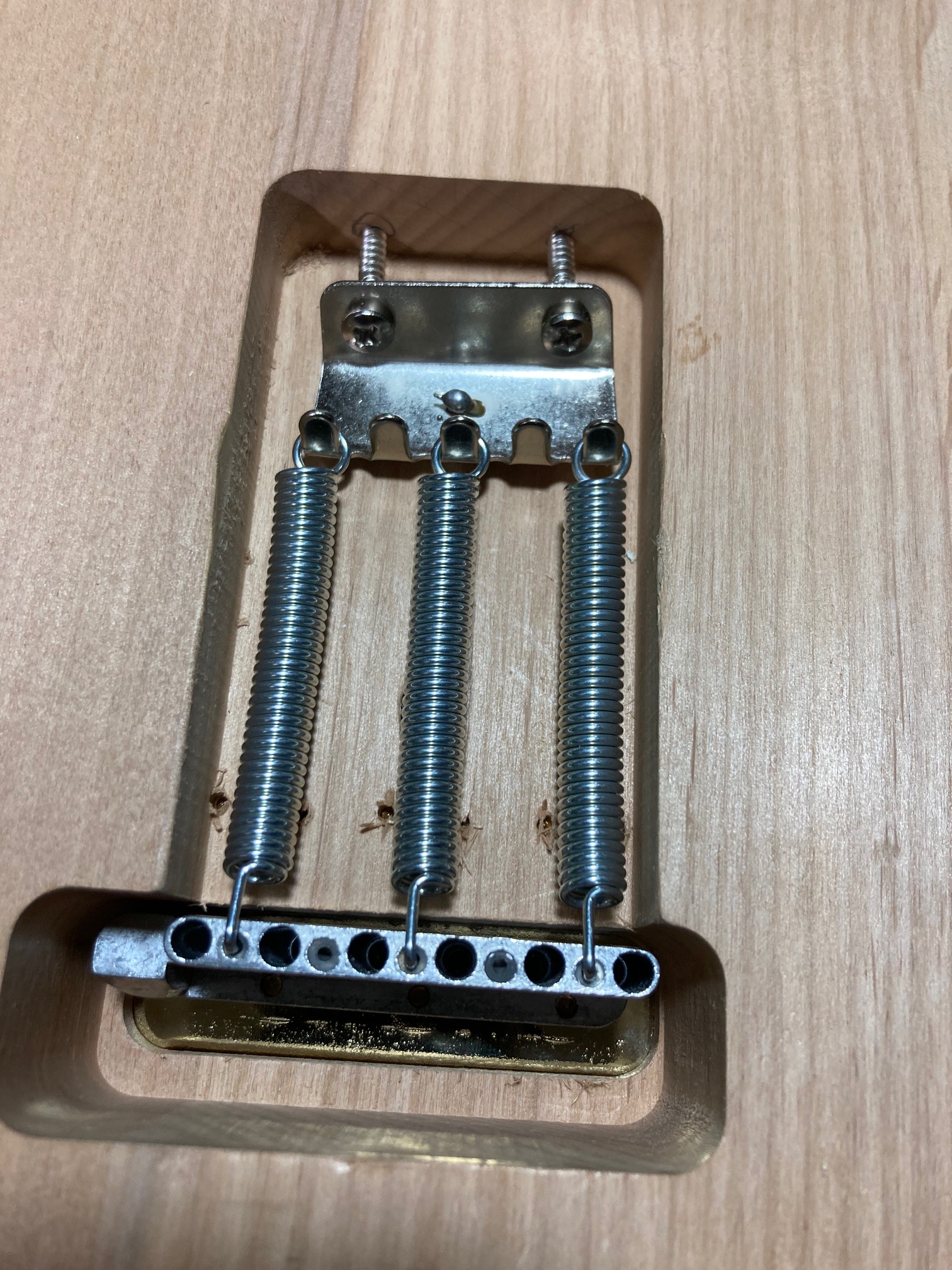 Spring claw and bridge are on. I couldn’t put in the screws for the springs evenly because of the aw