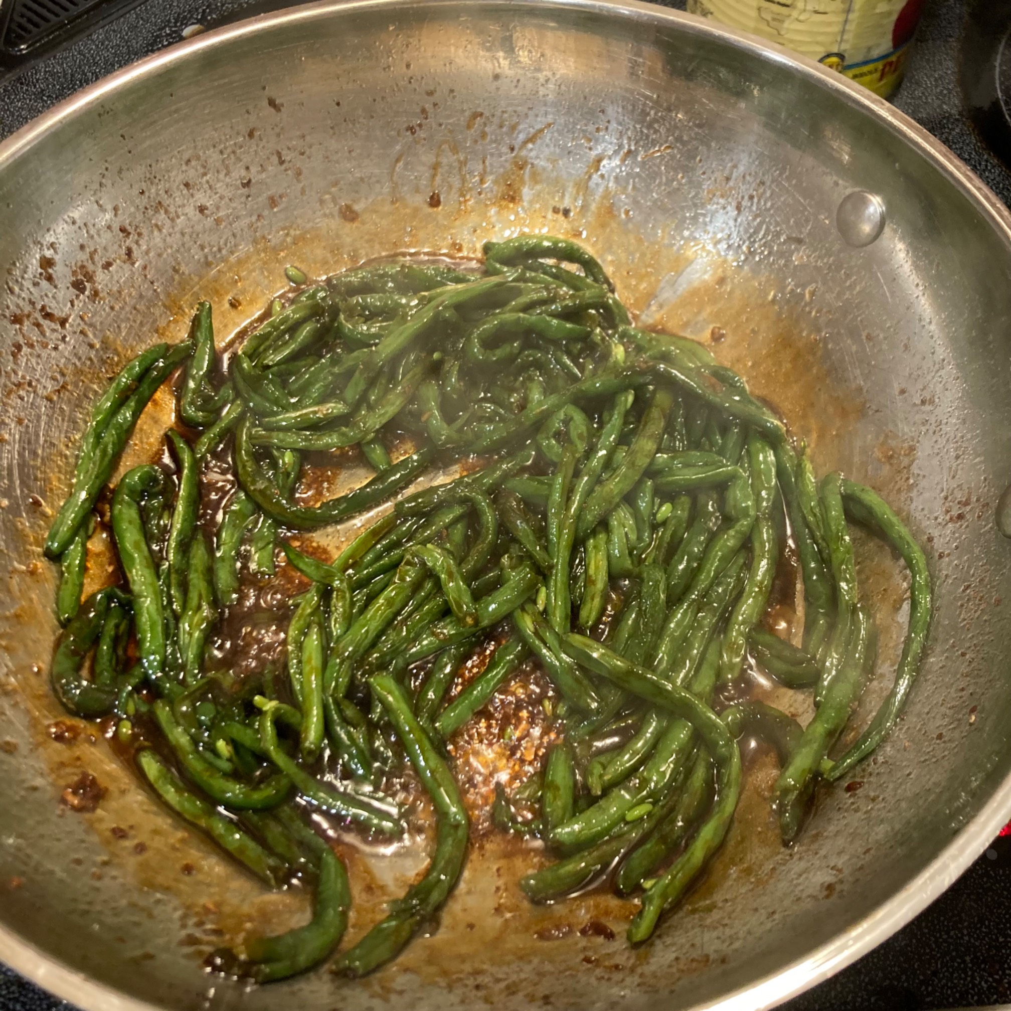 Green beans frying in sauce